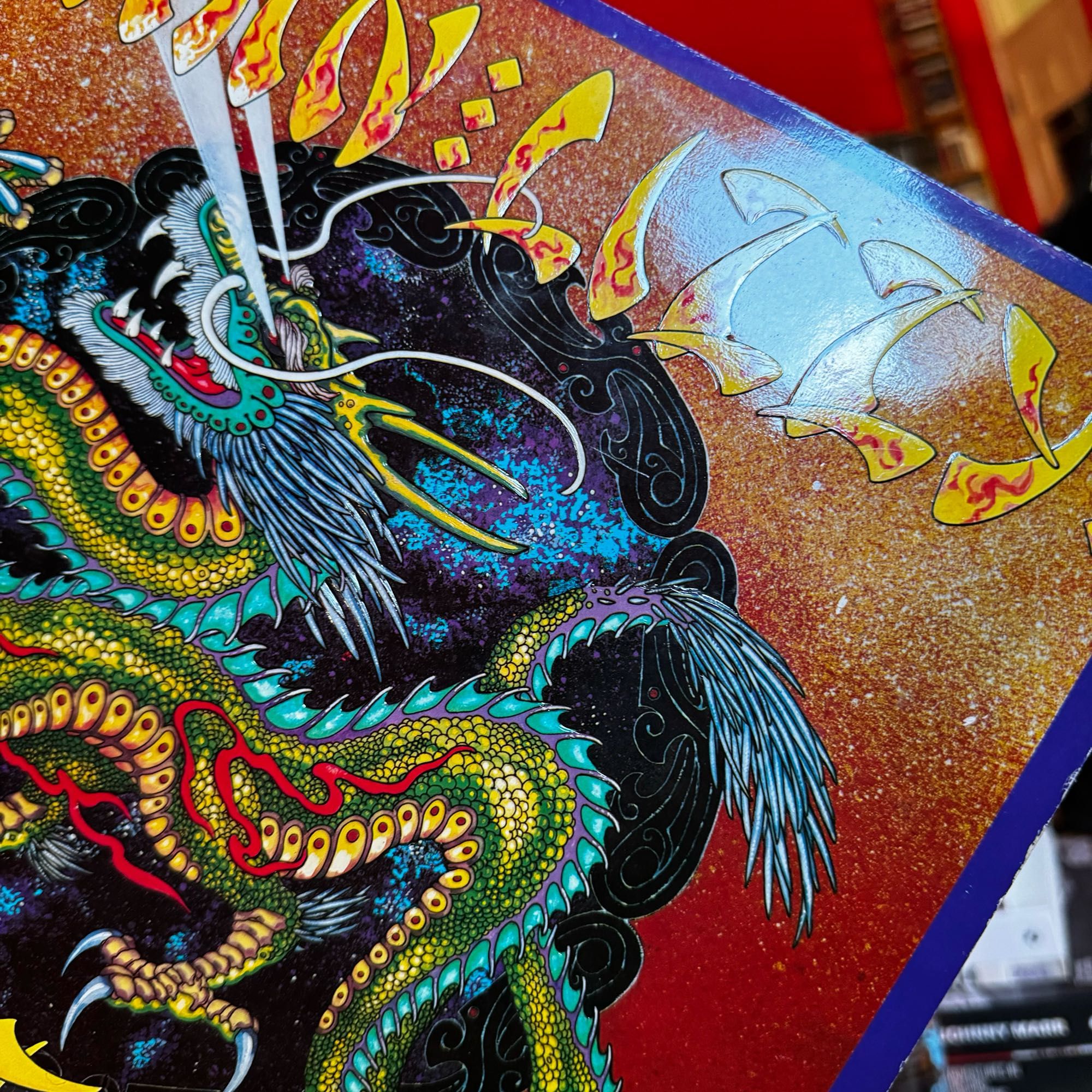 Cover art for Thin Lizzy Chinatown and a three toed dragon depicting the triads.