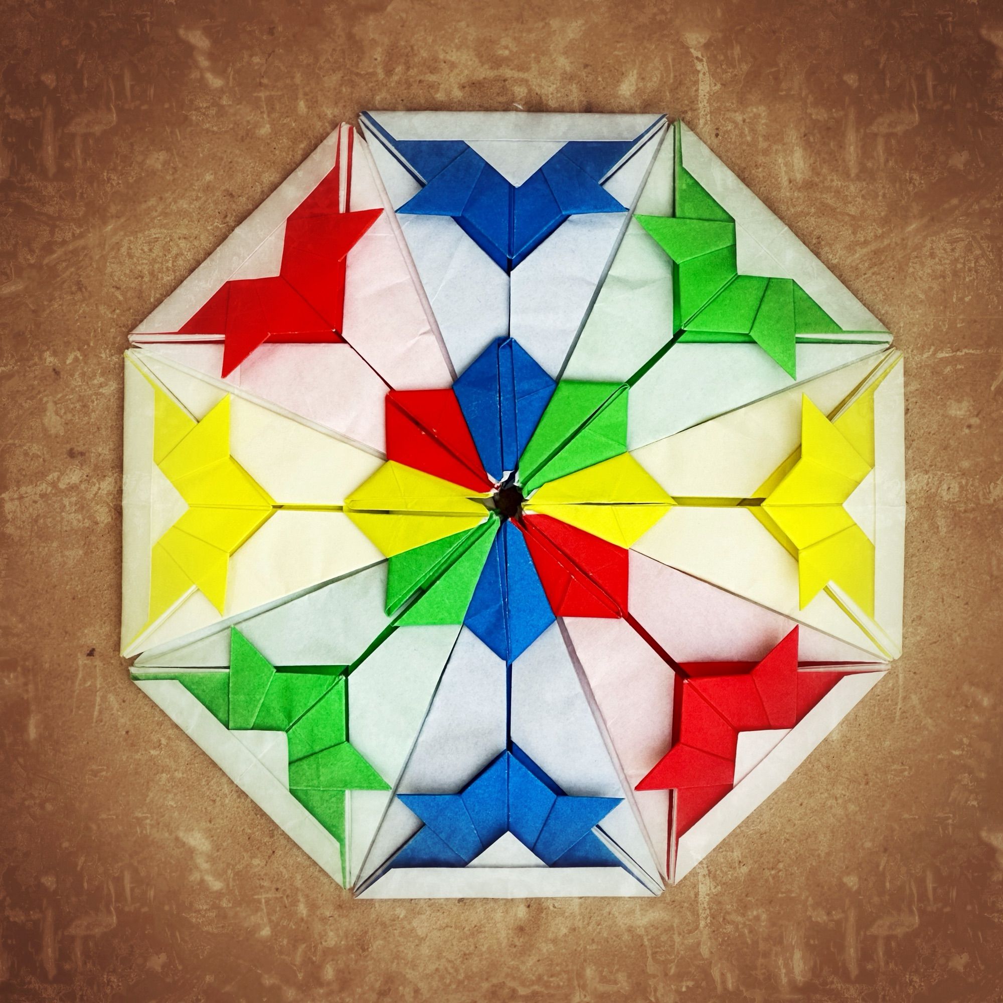 Colorful octagonal modular origami mandala incorporating the traditional origami samurai helmet as a decorative element