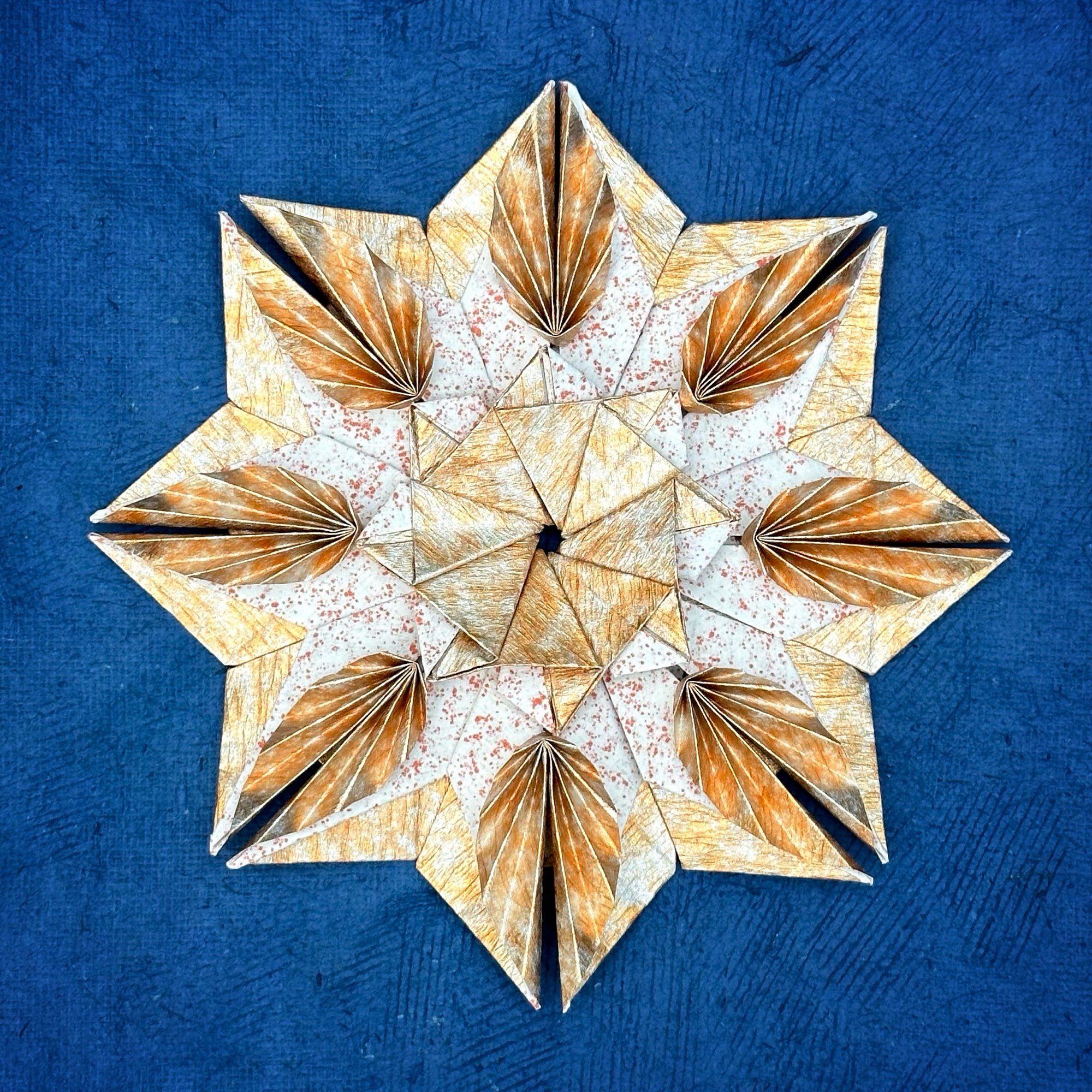 A good and white origami mandala on a dark blue background