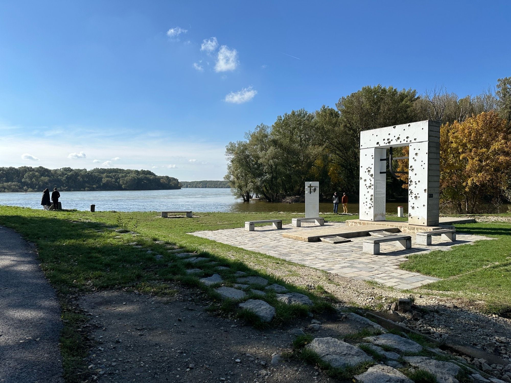 A monument showing bullet holes on a concrete frame