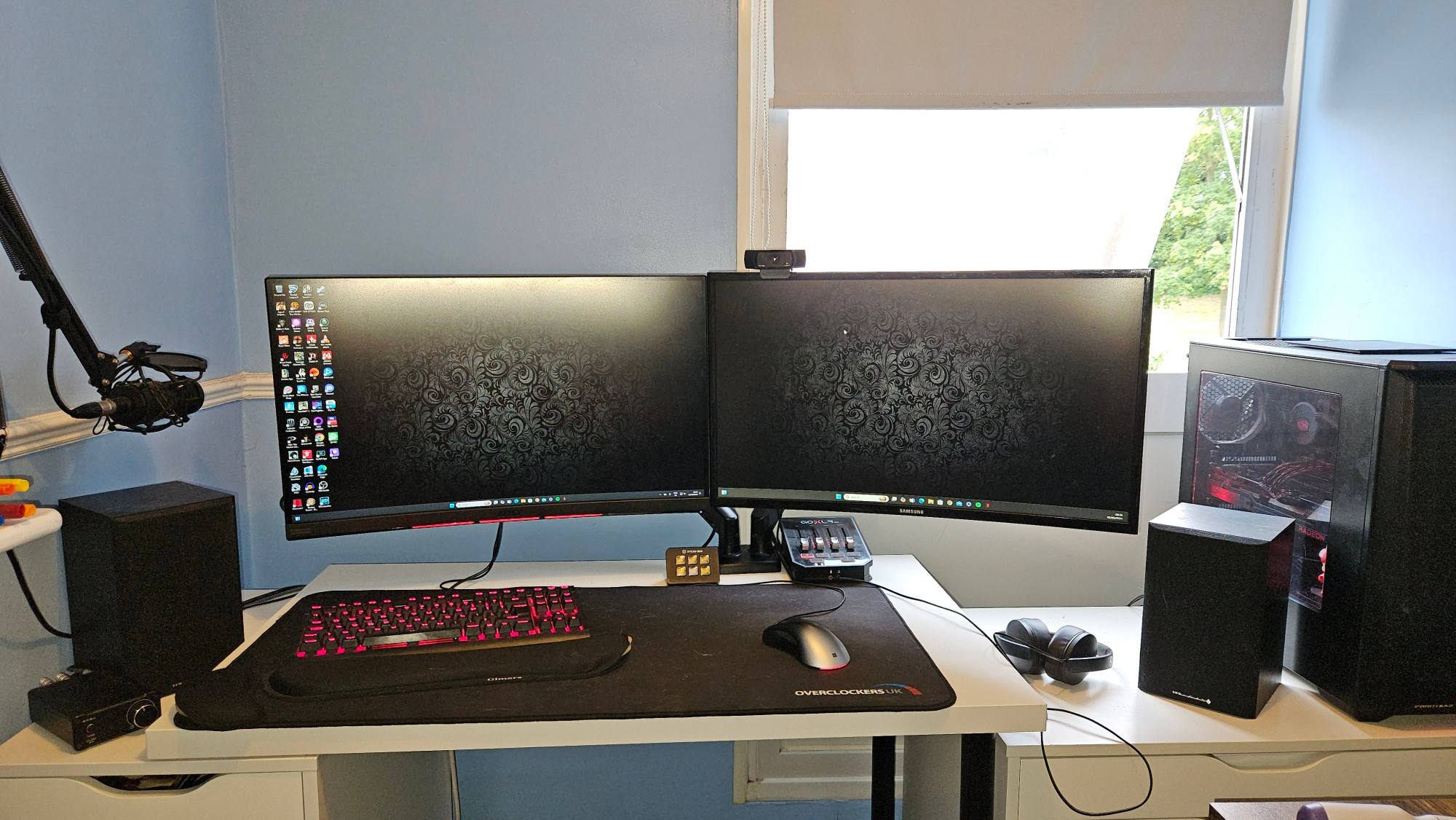 Desk with monitors in front of window