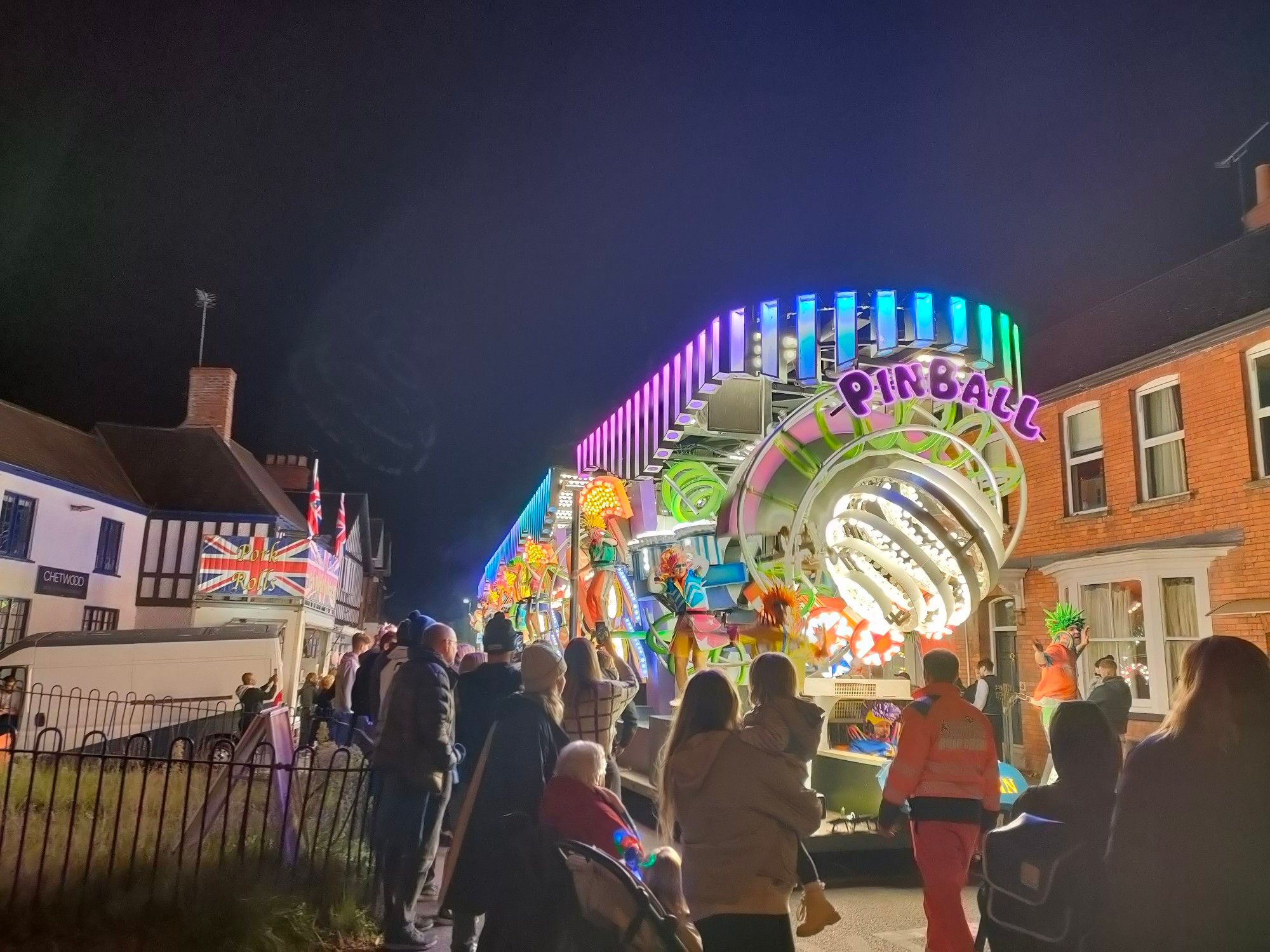 A pinball wizard themed illuminated carnival float seen largely from the front.