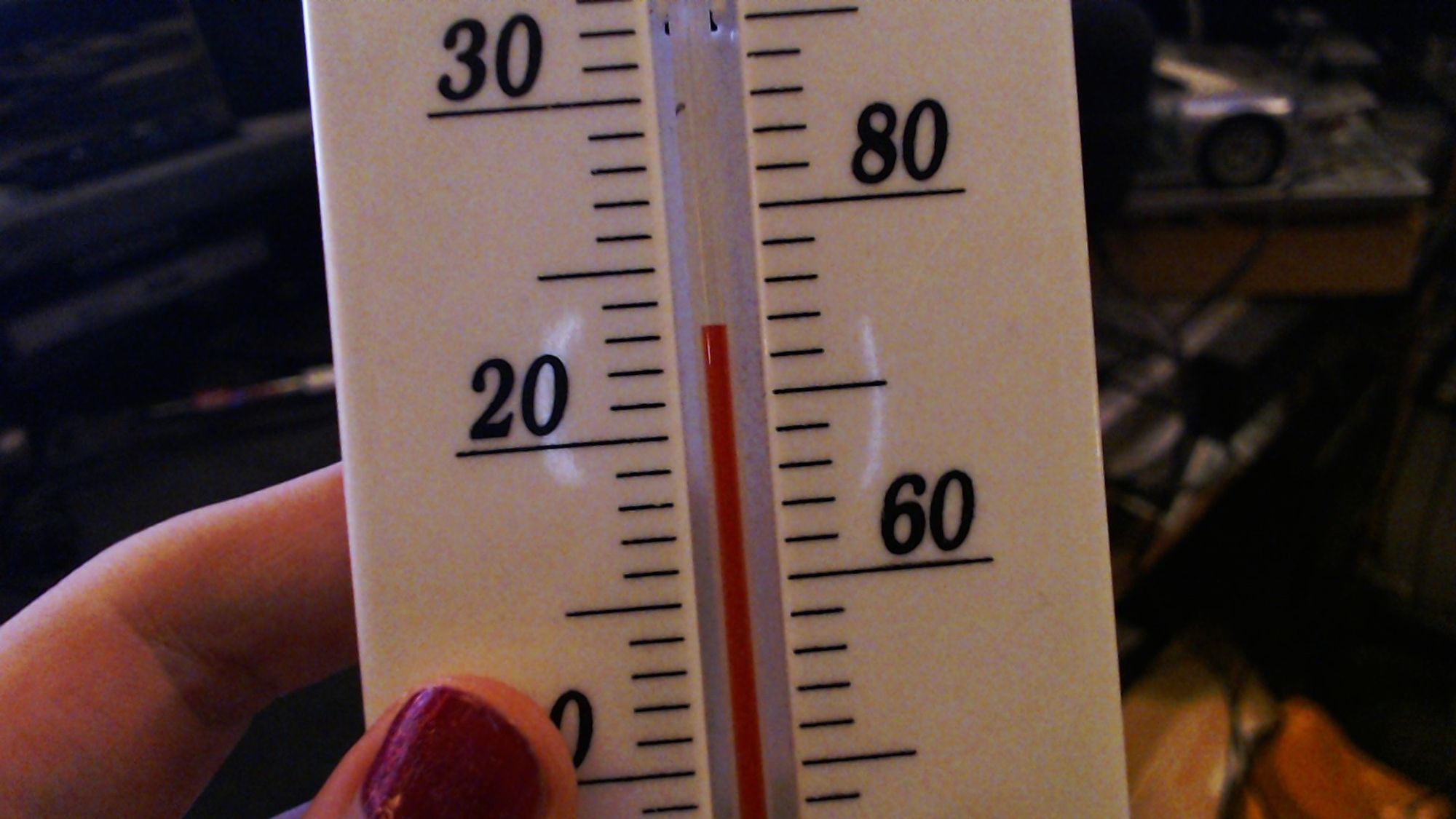 Aenore is holding a thermometer reading 23°C - 74°F