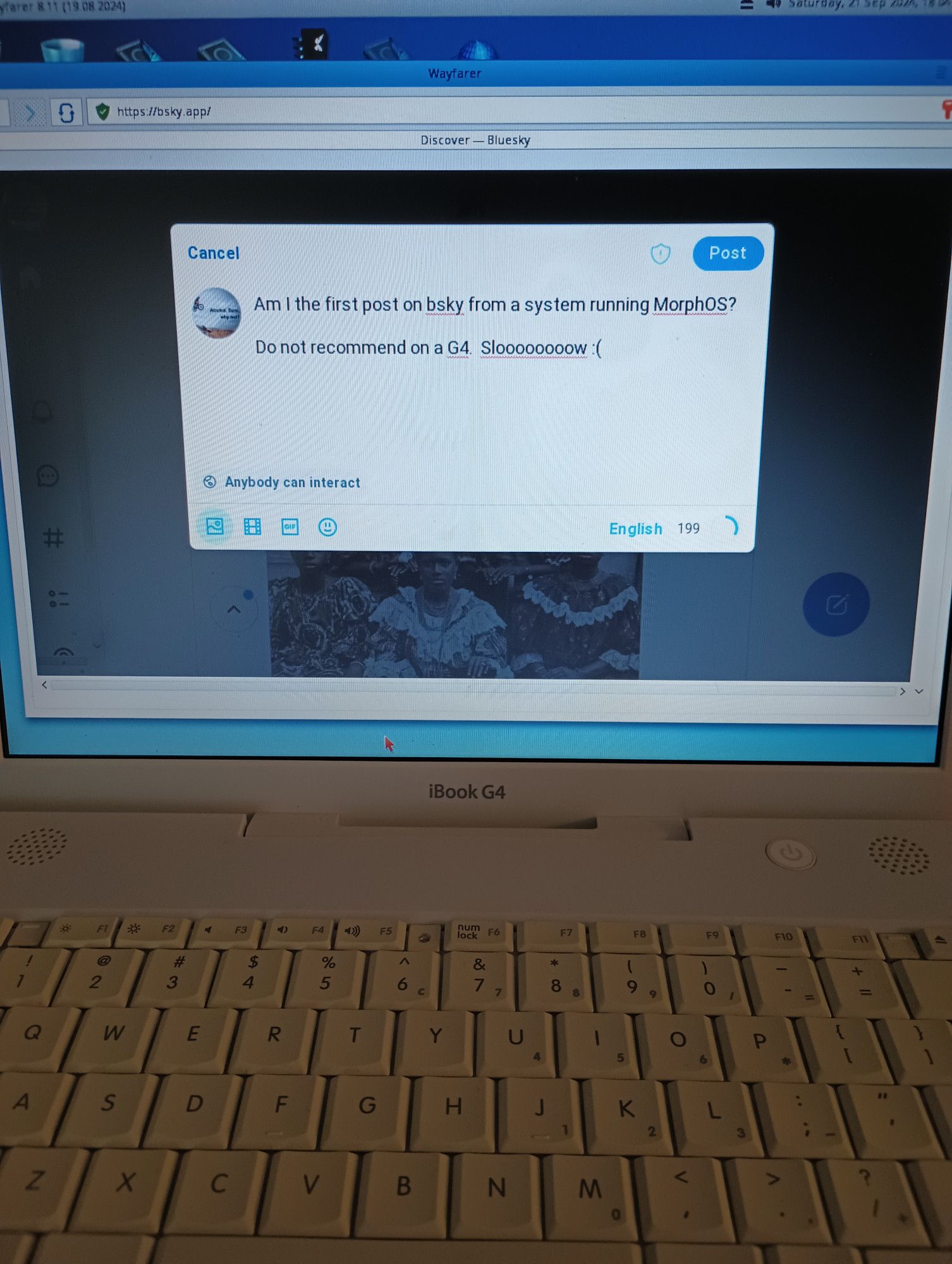 Picture of an iBook G4, running the Wayfarer browser in Morph OS, as I was posting on bluesky