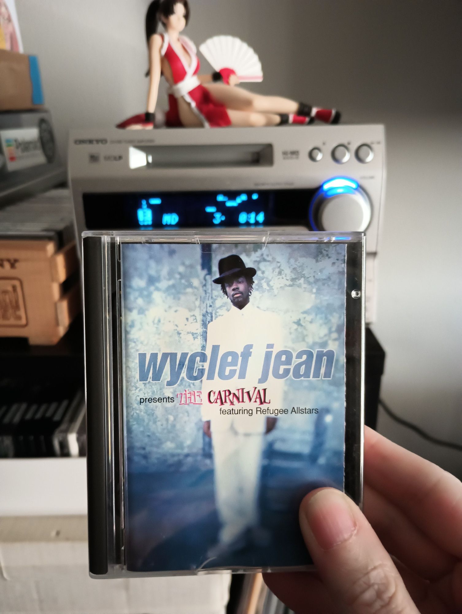 Foreground: Wyclef Jean Presents The Carnival
Background: Mai Shiranui guarding my minidisc head unit