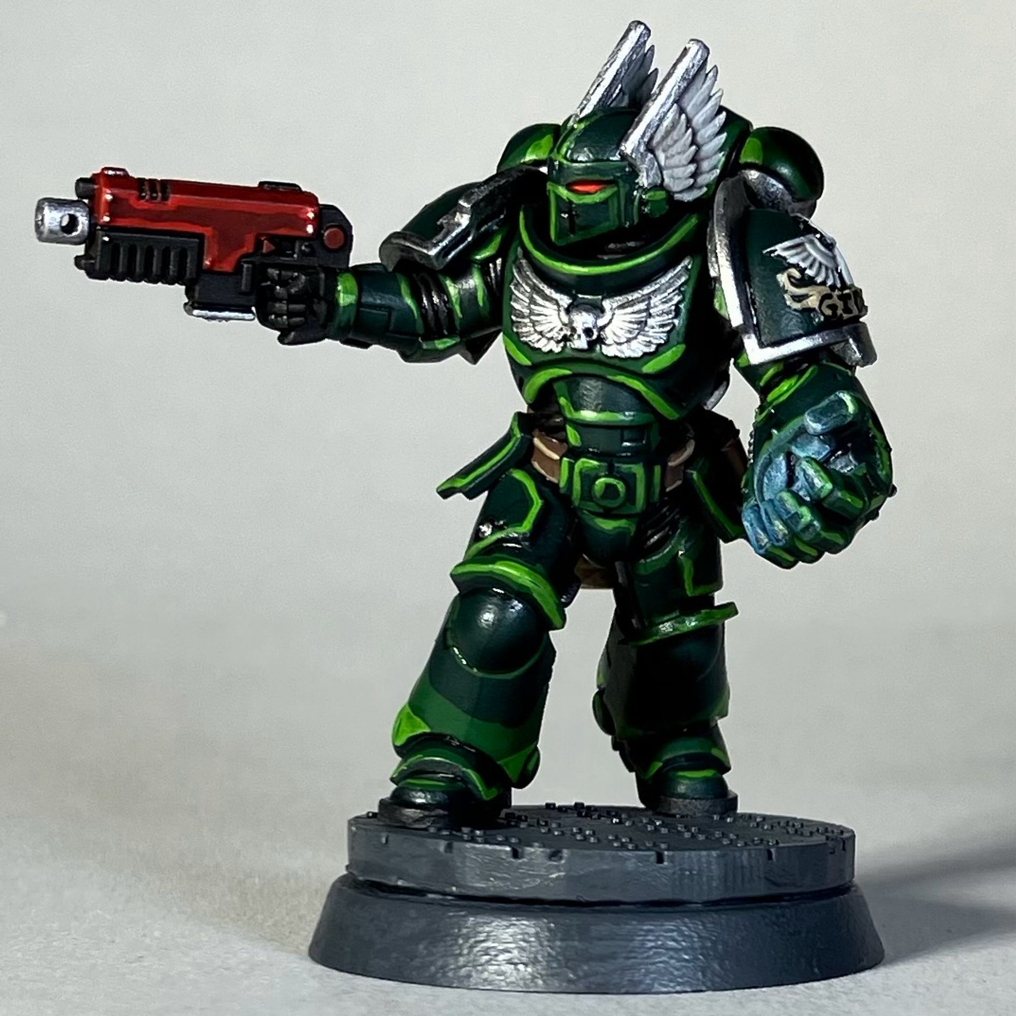 A Warhammer 40k Space Marine, Dark Angels Chapter, in green armor with a red weapon for the game Killteam