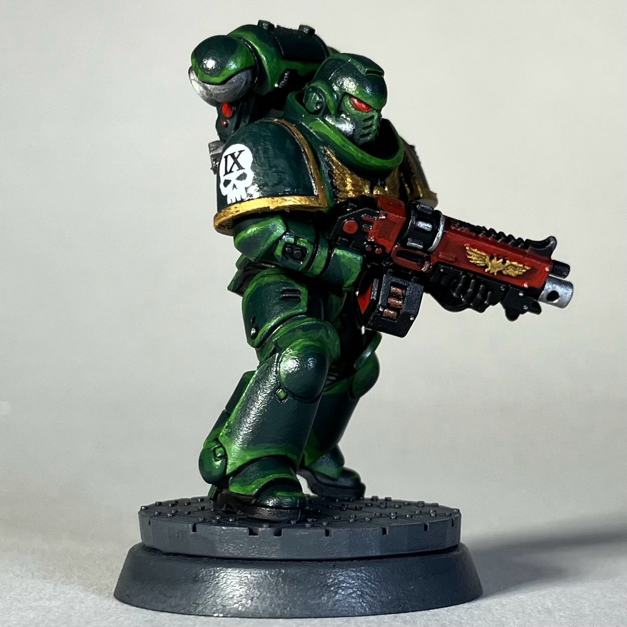 A Warhammer 40k Space Marine, Dark Angels Chapter, in green armor with a red weapon for the game Killteam