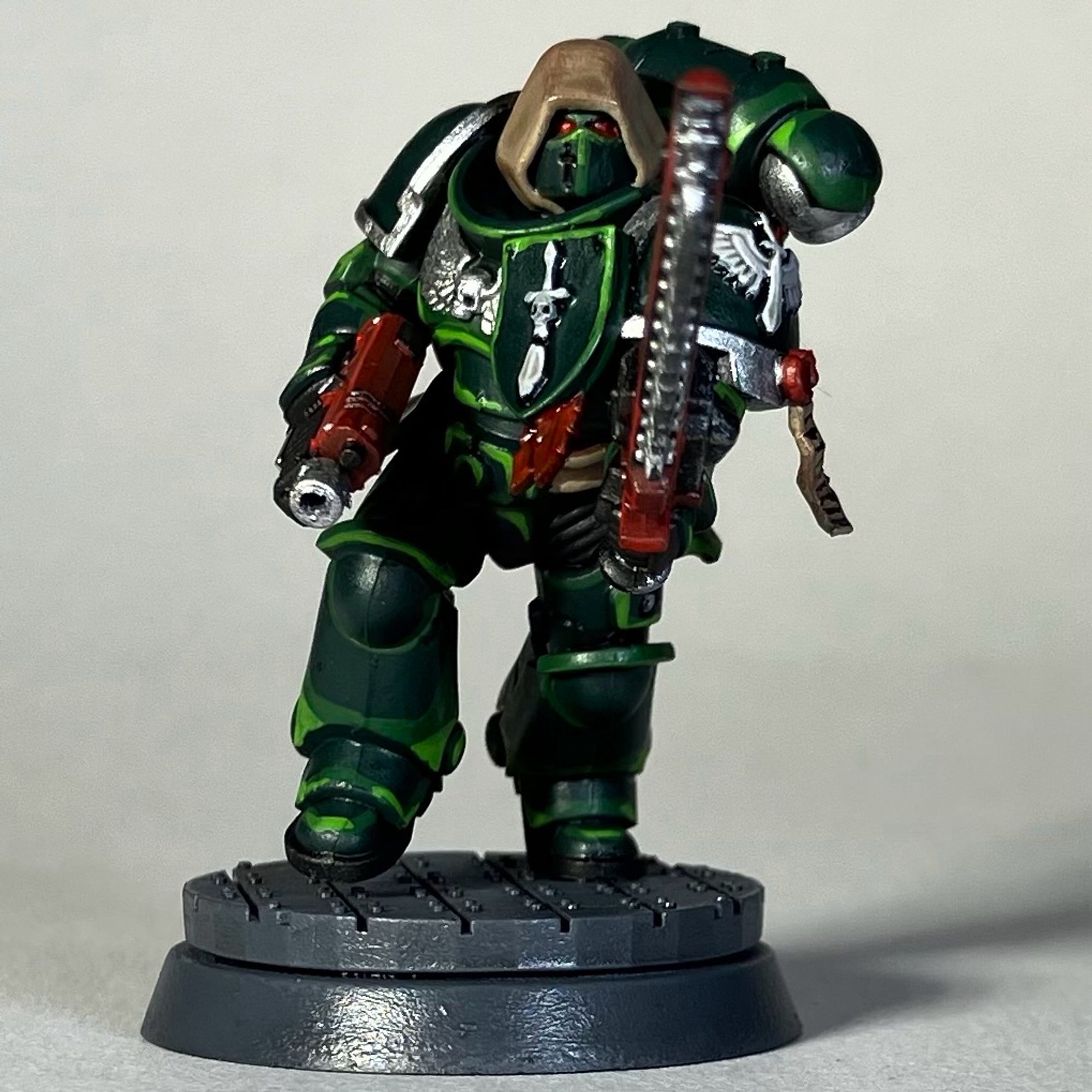 A Warhammer 40k Space Marine, Dark Angels Chapter, in green armor with a red weapon and red chainsword for the game Killteam