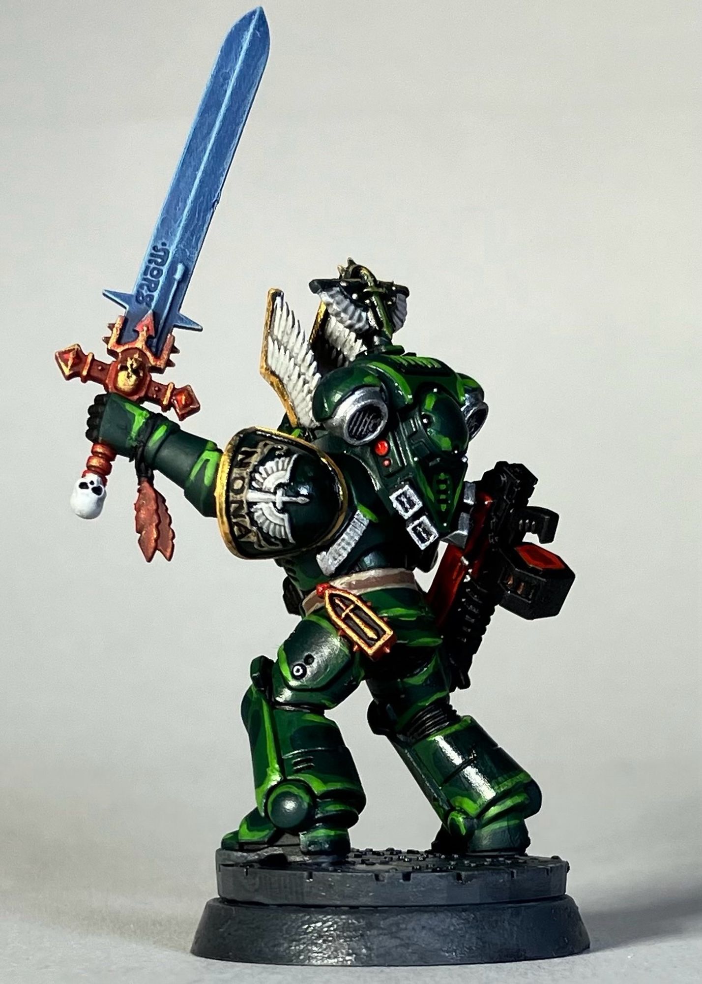 A Warhammer 40k Space Marine, Dark Angels Chapter, in green armor with a red weapon for the game Killteam