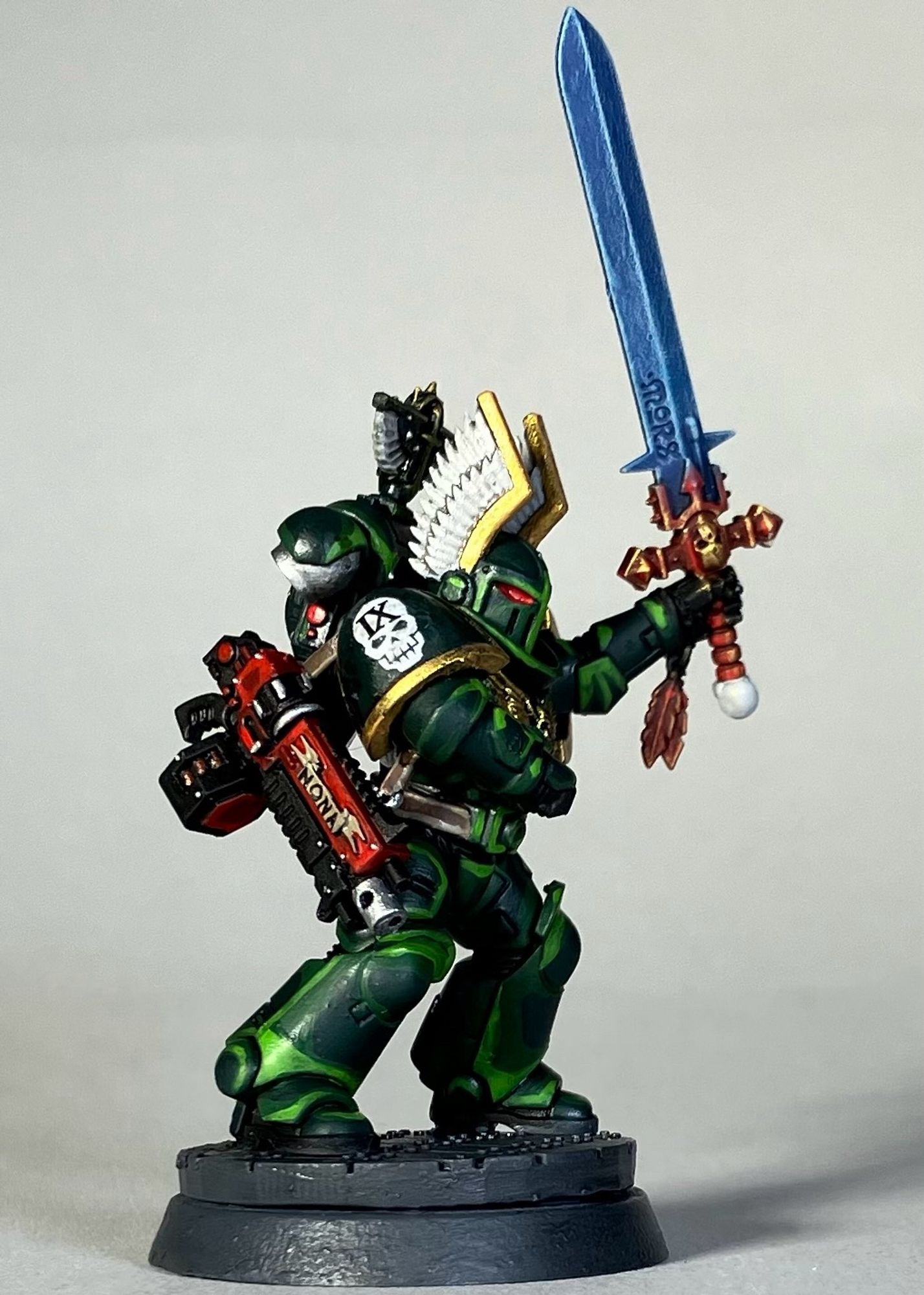 A Warhammer 40k Space Marine, Dark Angels Chapter, in green armor with a red weapon for the game Killteam