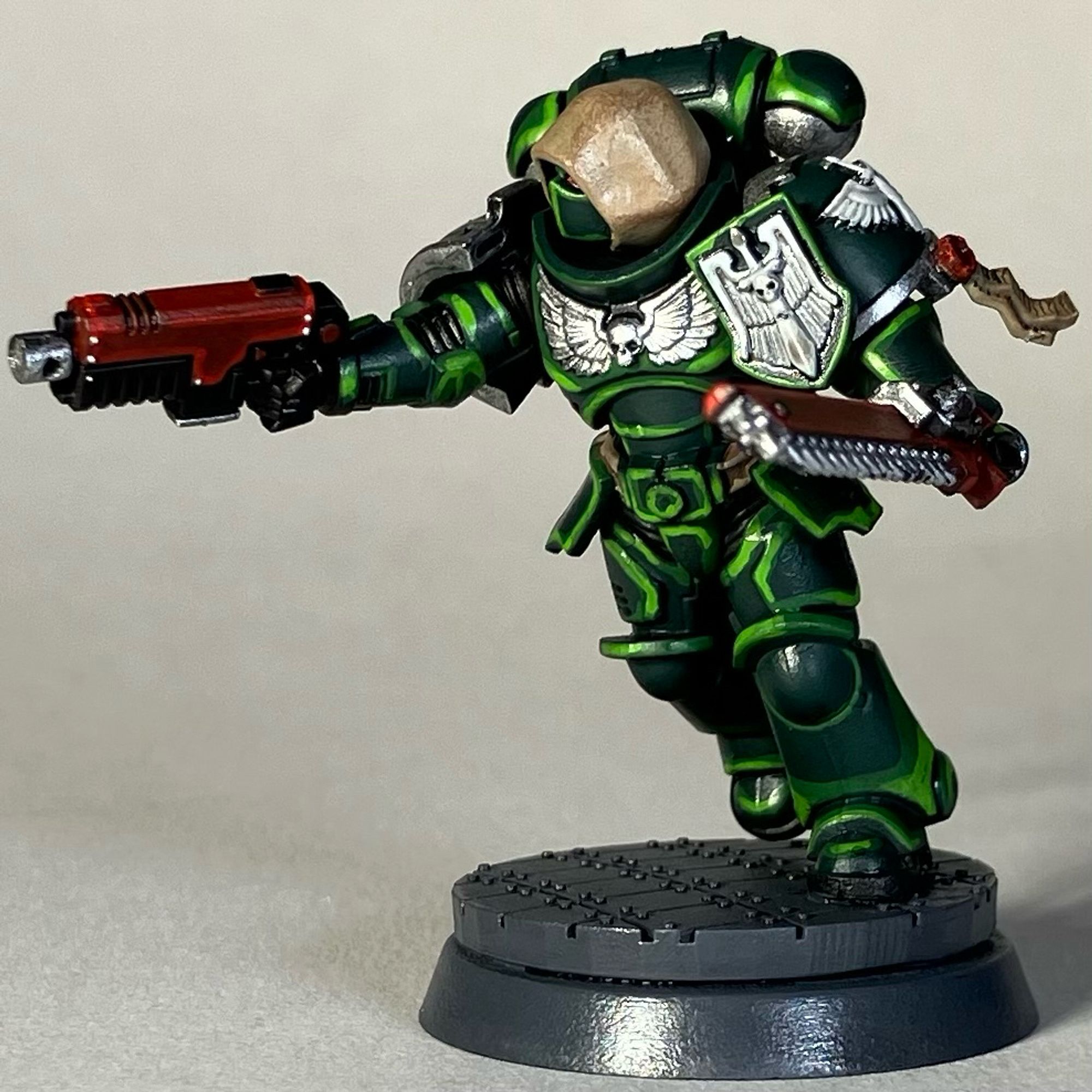 A Warhammer 40k Space Marine, Dark Angels Chapter, in green armor with a red weapon and red chainsword for the game Killteam