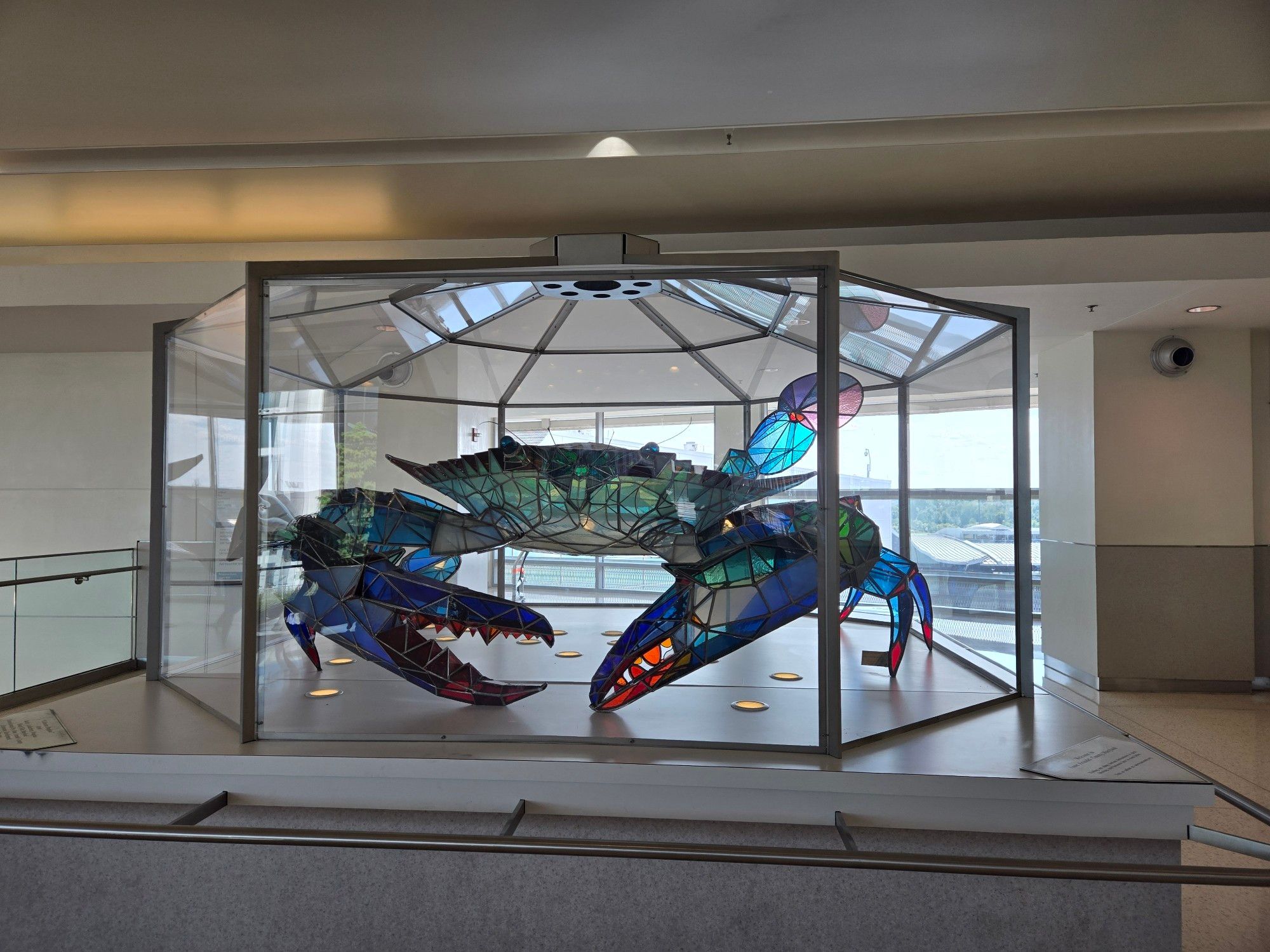 A large blue crab sculpture made of stained glass. About the size of a small sedan