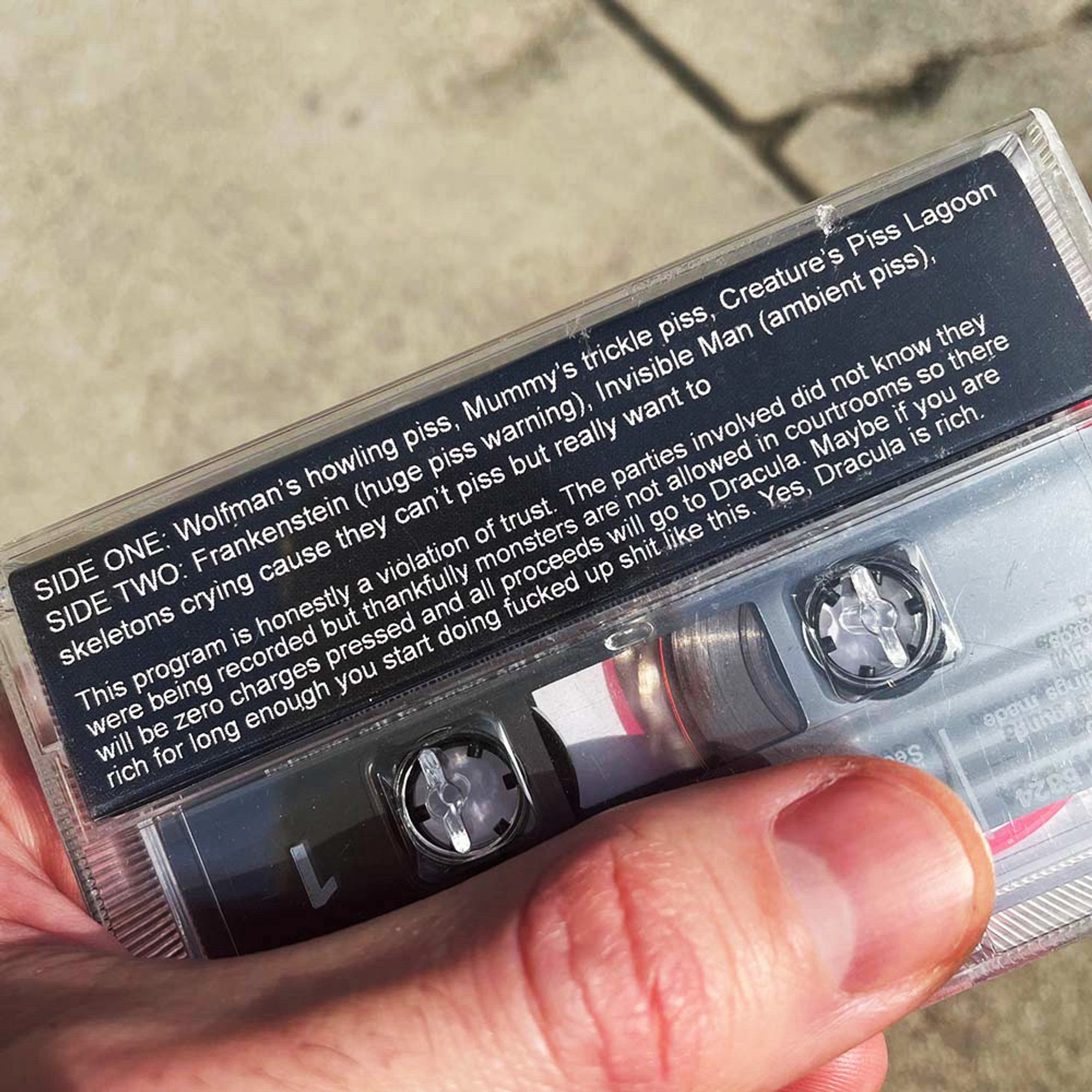 Track listing and copy reads: 

SIDE ONE: Wolfman's howling piss, Mummy's trickle piss, Creature's Piss Lagoon SIDE TWO: Frankenstein (huge piss warning), Invisible Man (ambient piss), skeletons crying cause they can't piss but really want to

This program is honestly a violation of trust. The parties involved did not know they were being recorded but thankfully monsters are not allowed in courtrooms so there will be zero charges pressed and all proceeds will go to Dracula. Maybe if you are rich for long enough you start doing fucked up shit like this. Yes, Dracula is rich.