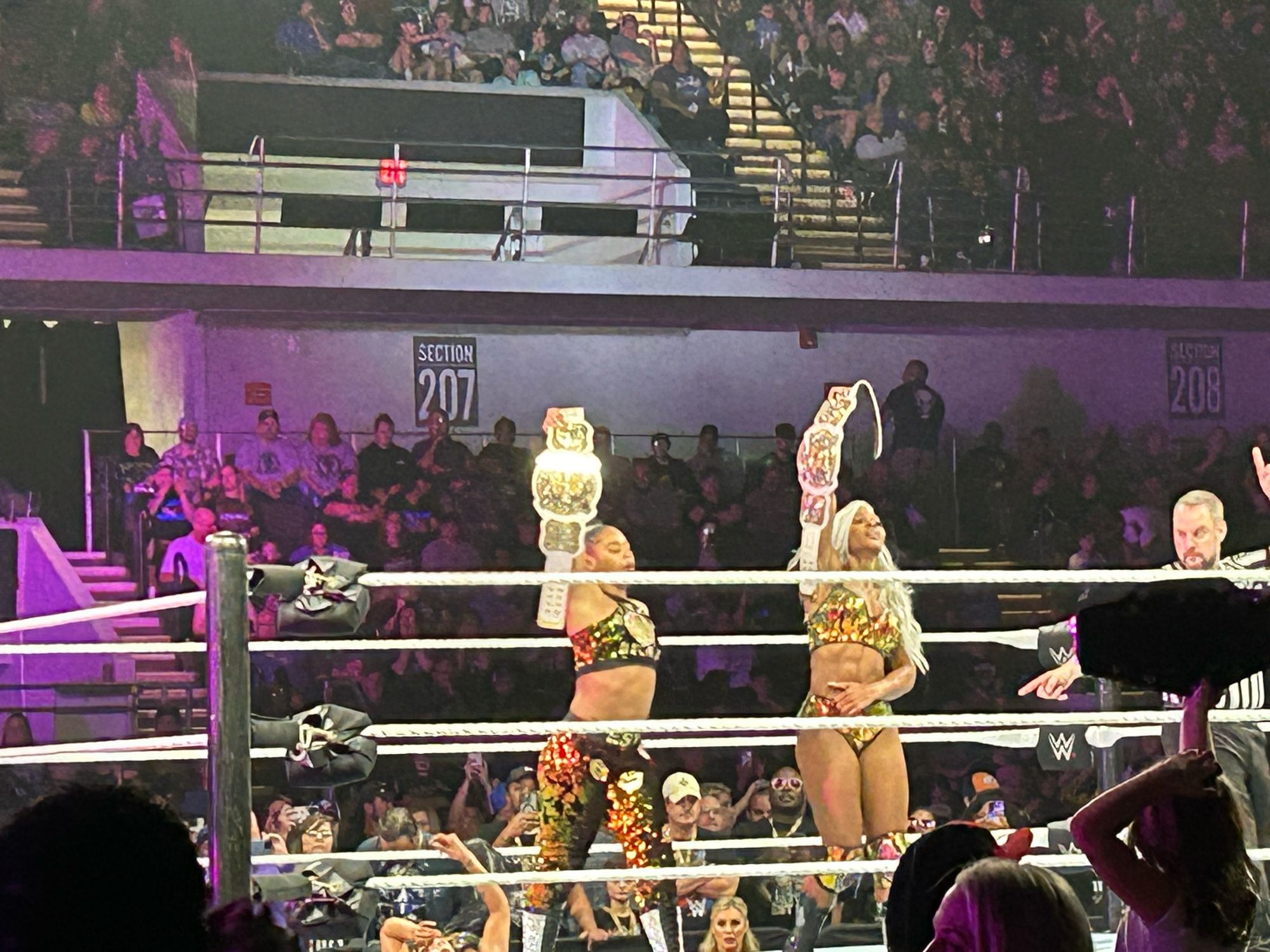 Wrestlers Bianca Belair and Jade Cargill hold up their title belts