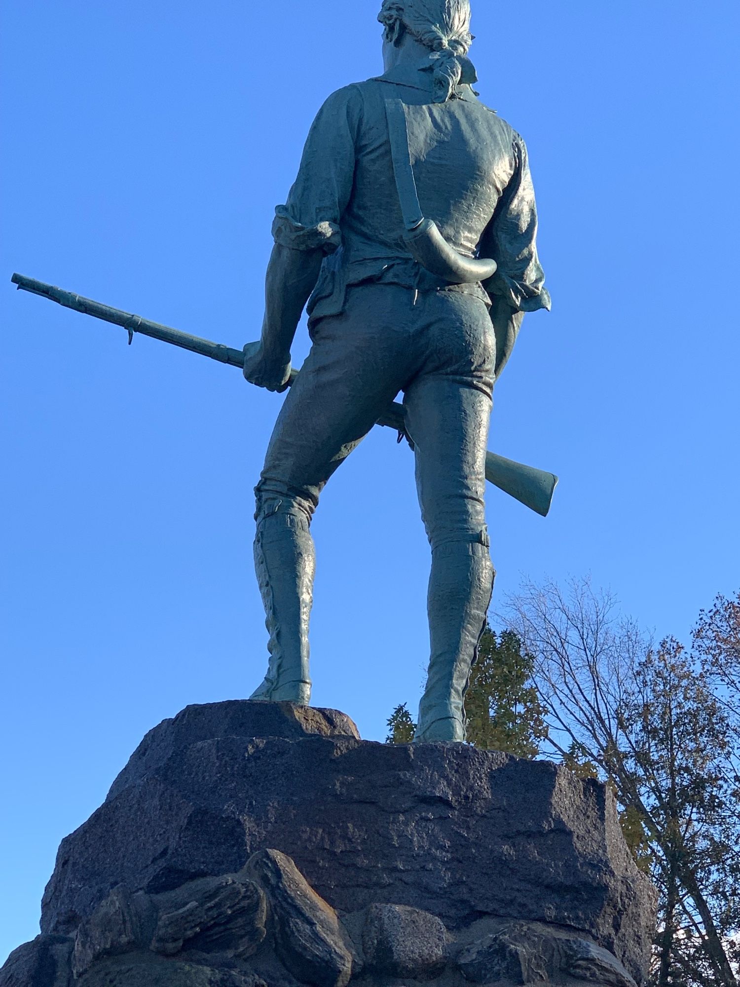 rear view of the statue of revolutionary war minuteman John Parker, who fought in the battle of concord  - enhance 