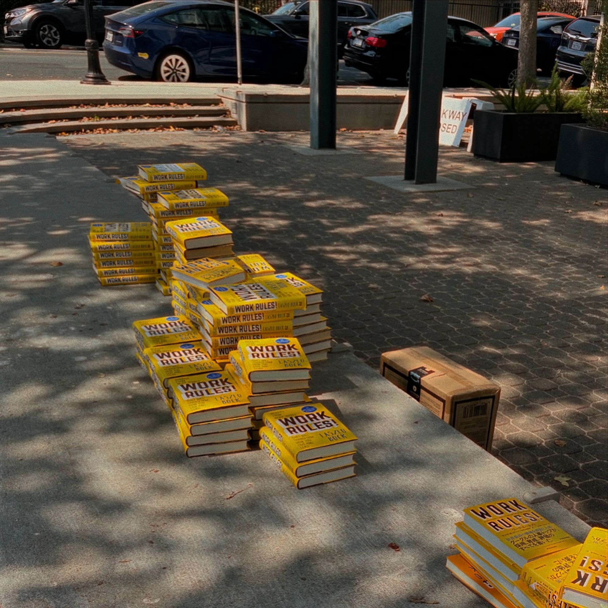 Several dozen copies of one book are stacked on a public bench in Mountain View, California. The book is “Work Rules!” by Laszlo Bock. Although they’ve been there for several hours and the bench is less than a block away from the Sunday farmers’ market, only a few copies have been taken.