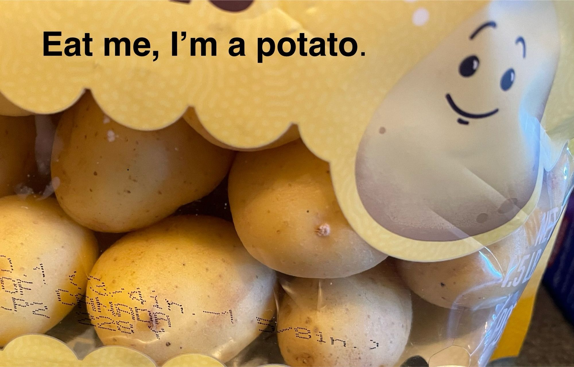 A package of small potatoes with a cartoon of a cute, smiling potato. There is a line of text which reads “Eat me, I’m a potato.”