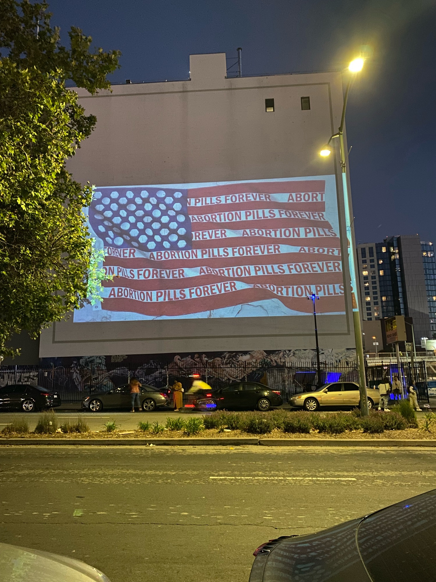 Projected flag with text abortion pills forever