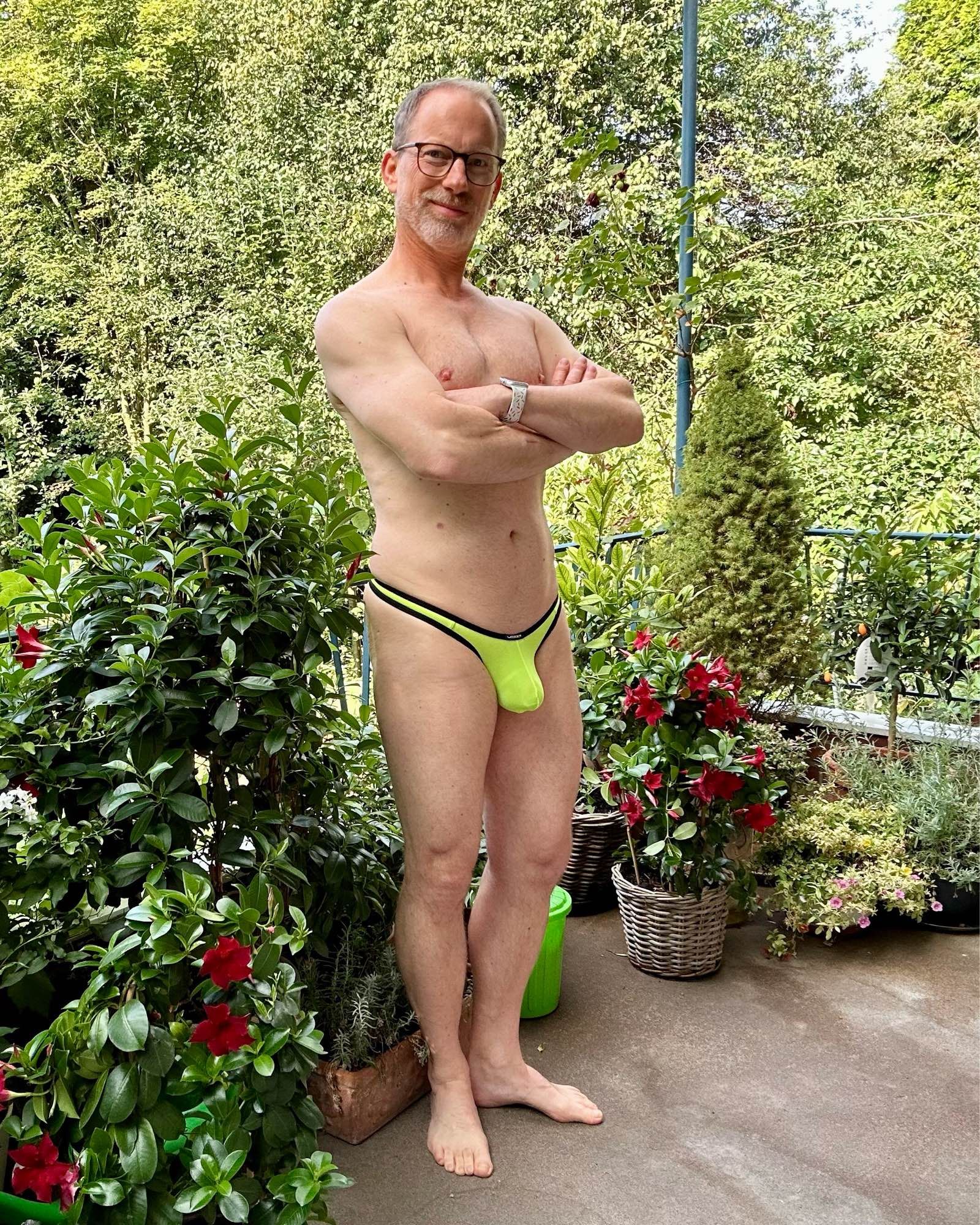 Wearing a neon yellow Wojoer thong with black trimmings on the deck