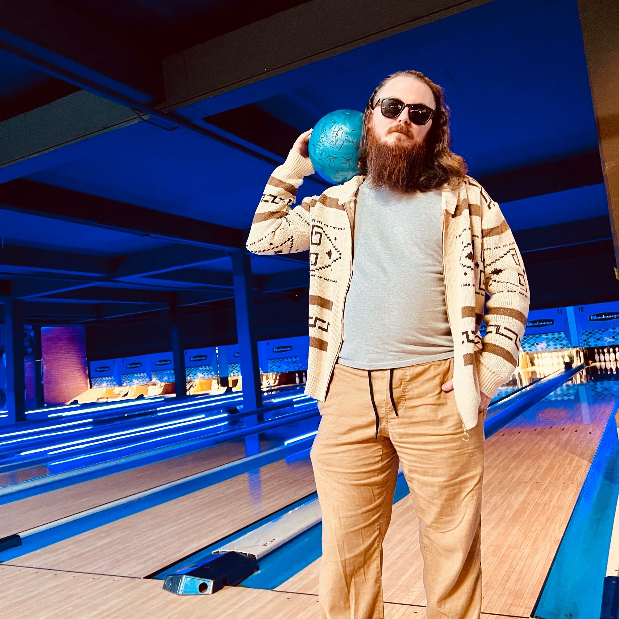 Me dressed as The Dude from The Big Lebowski standing in a bowling alley.