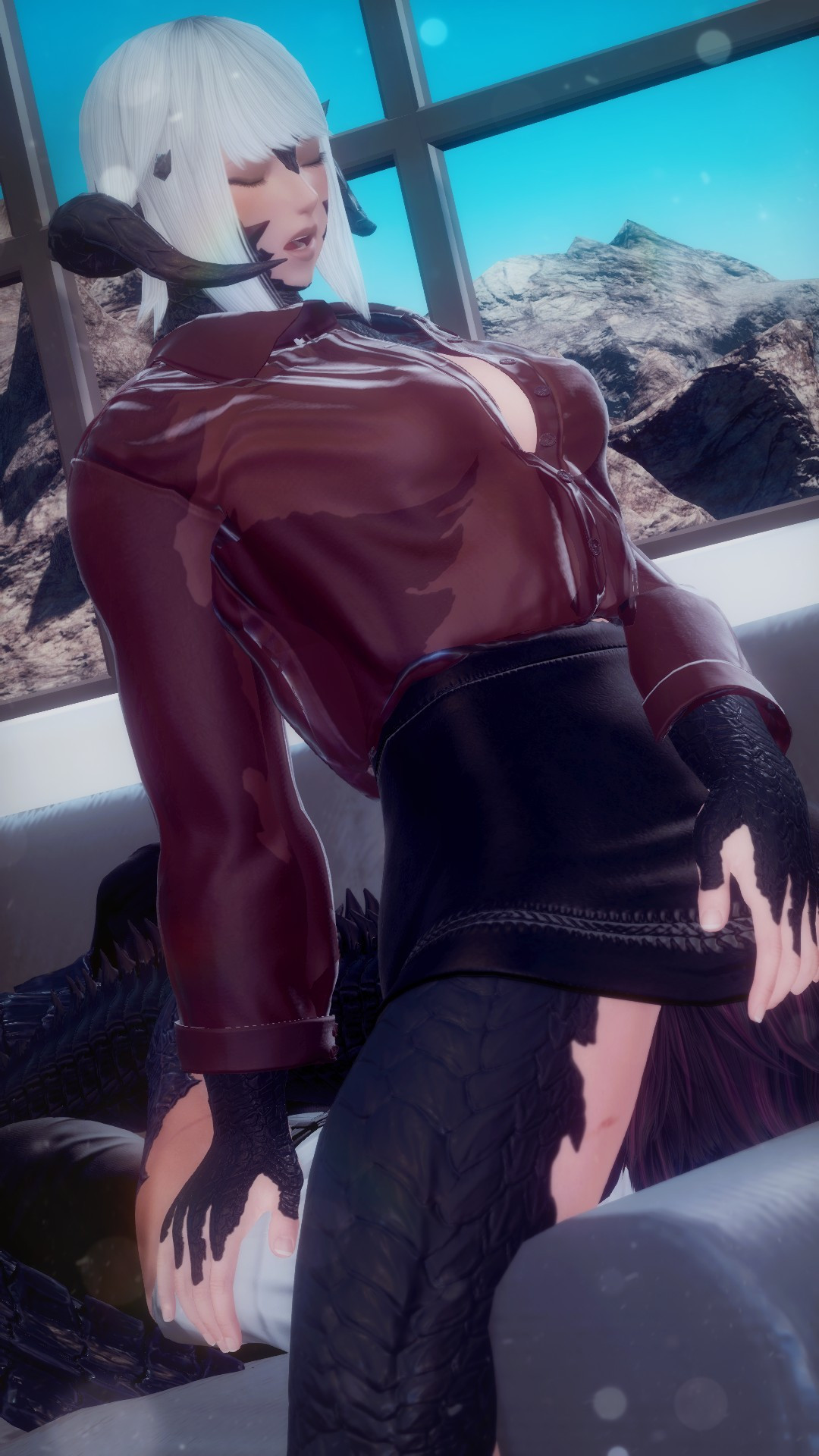 Dorgono sits upon a grey couch in a modern-looking room, dressed in a partially transparent wine red button-up shirt and an opaque black pencil skirt. Beneath her, Zaya Dalamiq lays on her back, her face obscured by Dorgono's skirt.