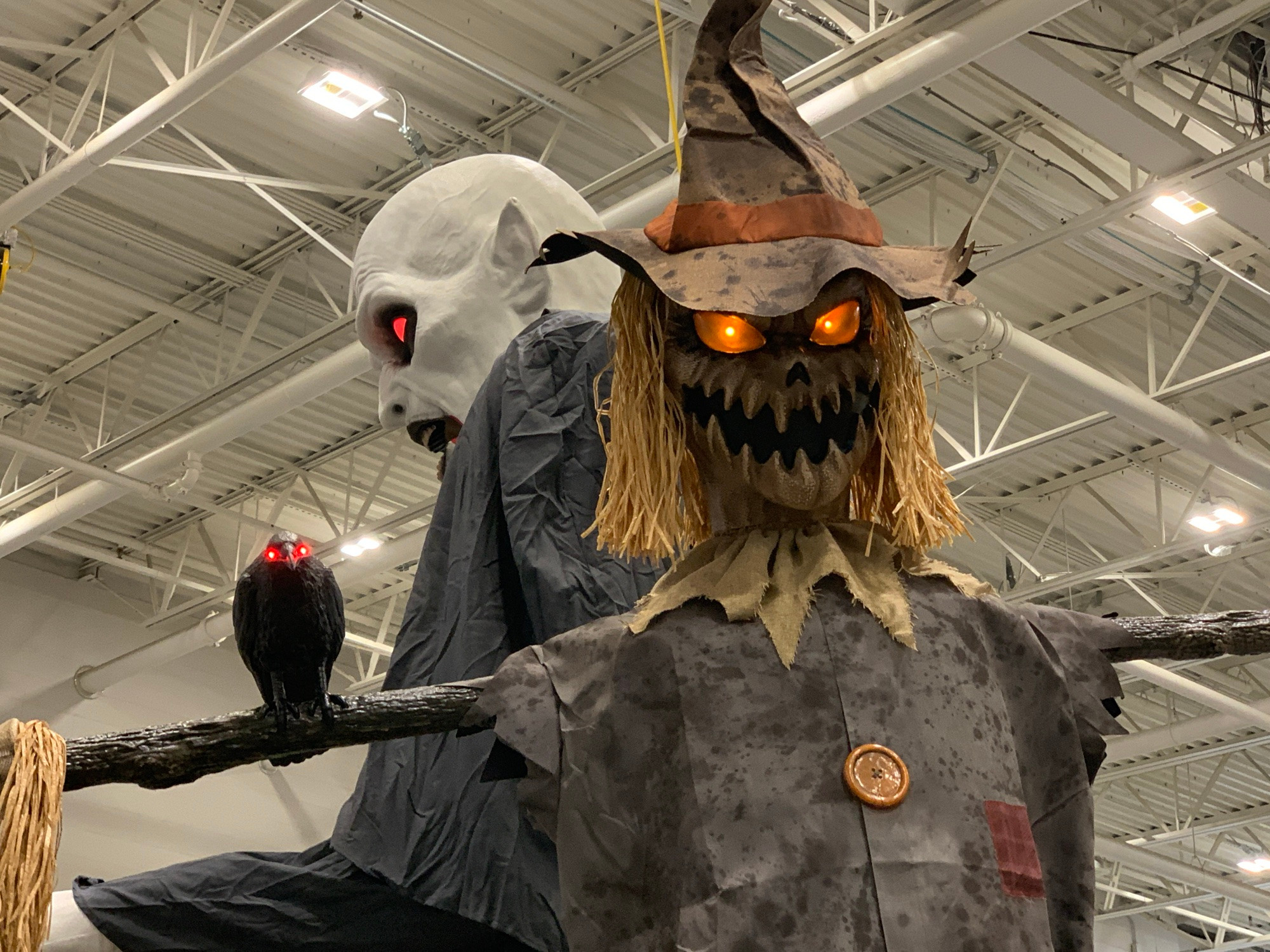 A large Nosferatu-like vampire and giant scarecrow, each with glowing red eyes.