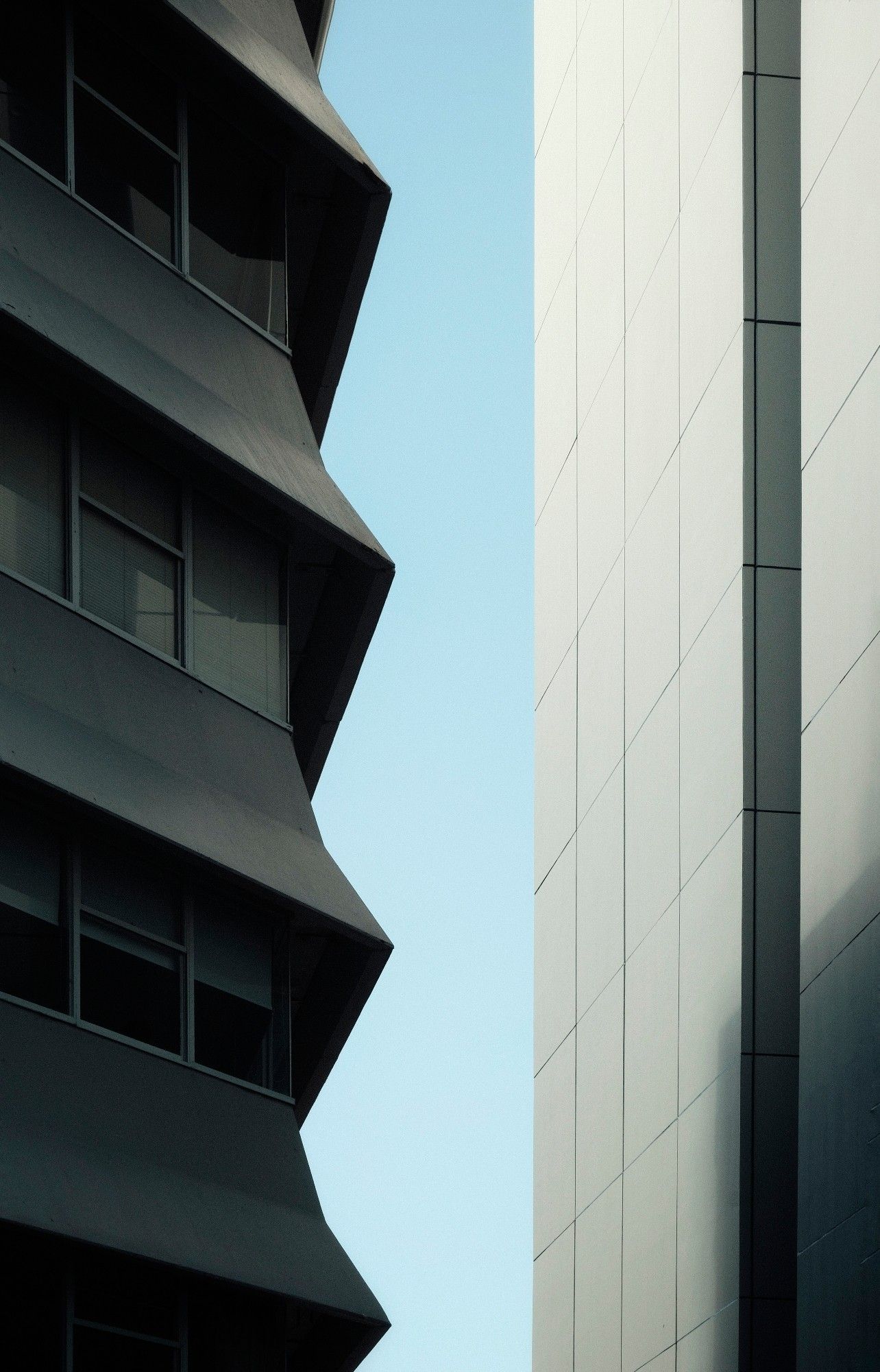 Architectural minimalistic photography. Two skyscrapers face to face. The first is in eastern architecture, the second is western