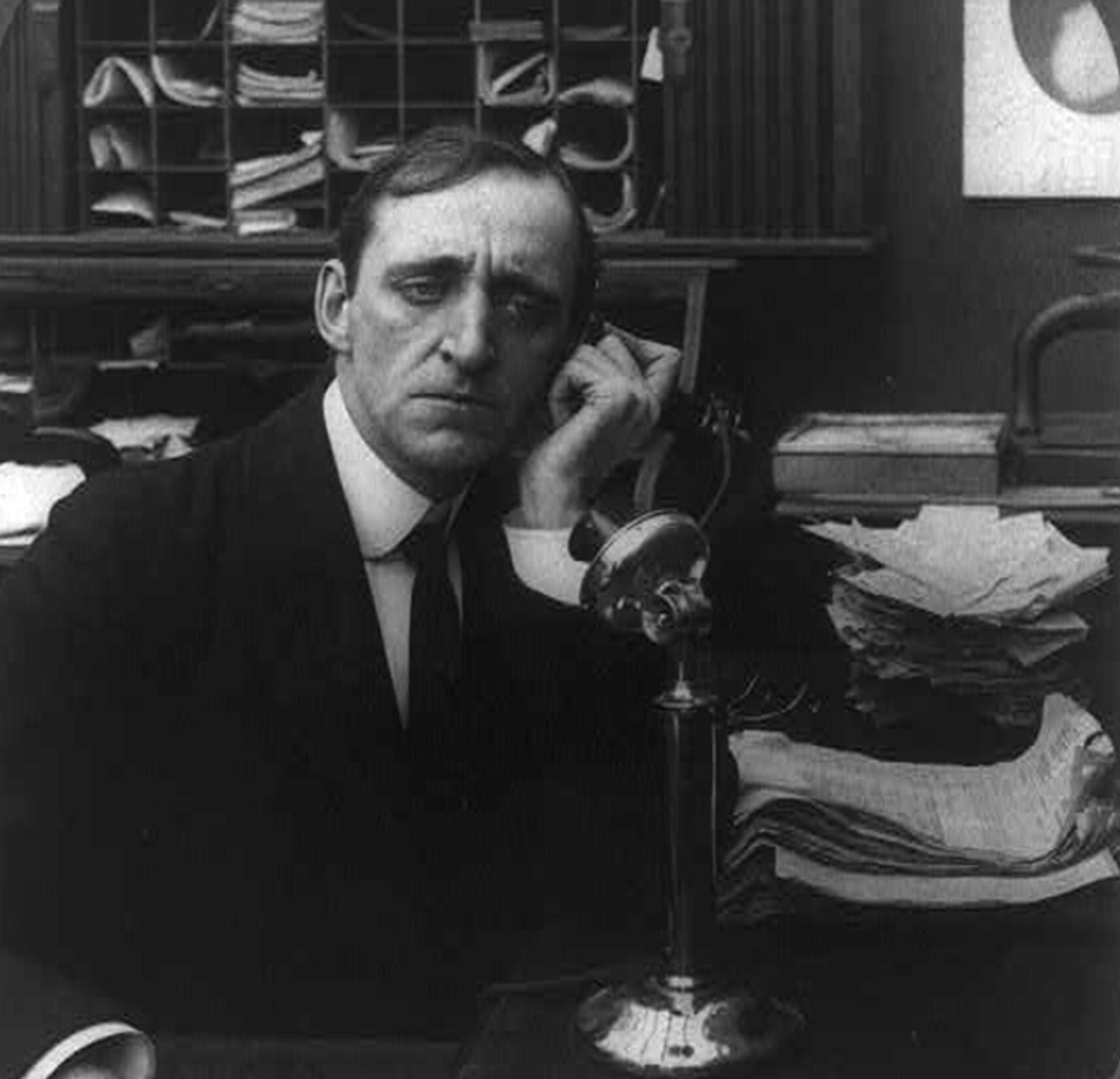 1906 Black and White image of man on telephone.