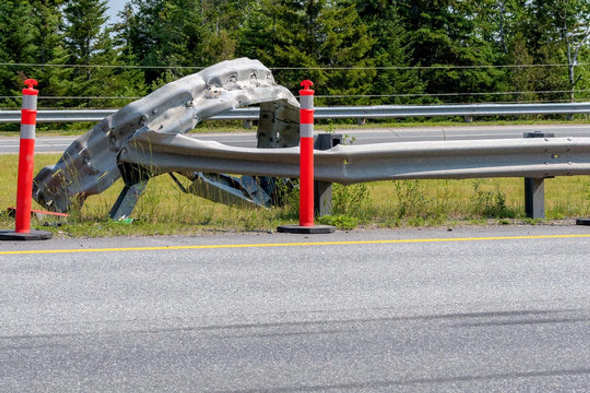 A mangled and useless guardrail on a highway, likely after a judge crashed an Appellate Court into it by making up bullsh*t not in the constitution (OK, I'm extrapolating here).
Fortunately, two plastic traffic warning wands mark the missing rail. Because plastic will stop a speeding SCOTUS from further wrecking everything.