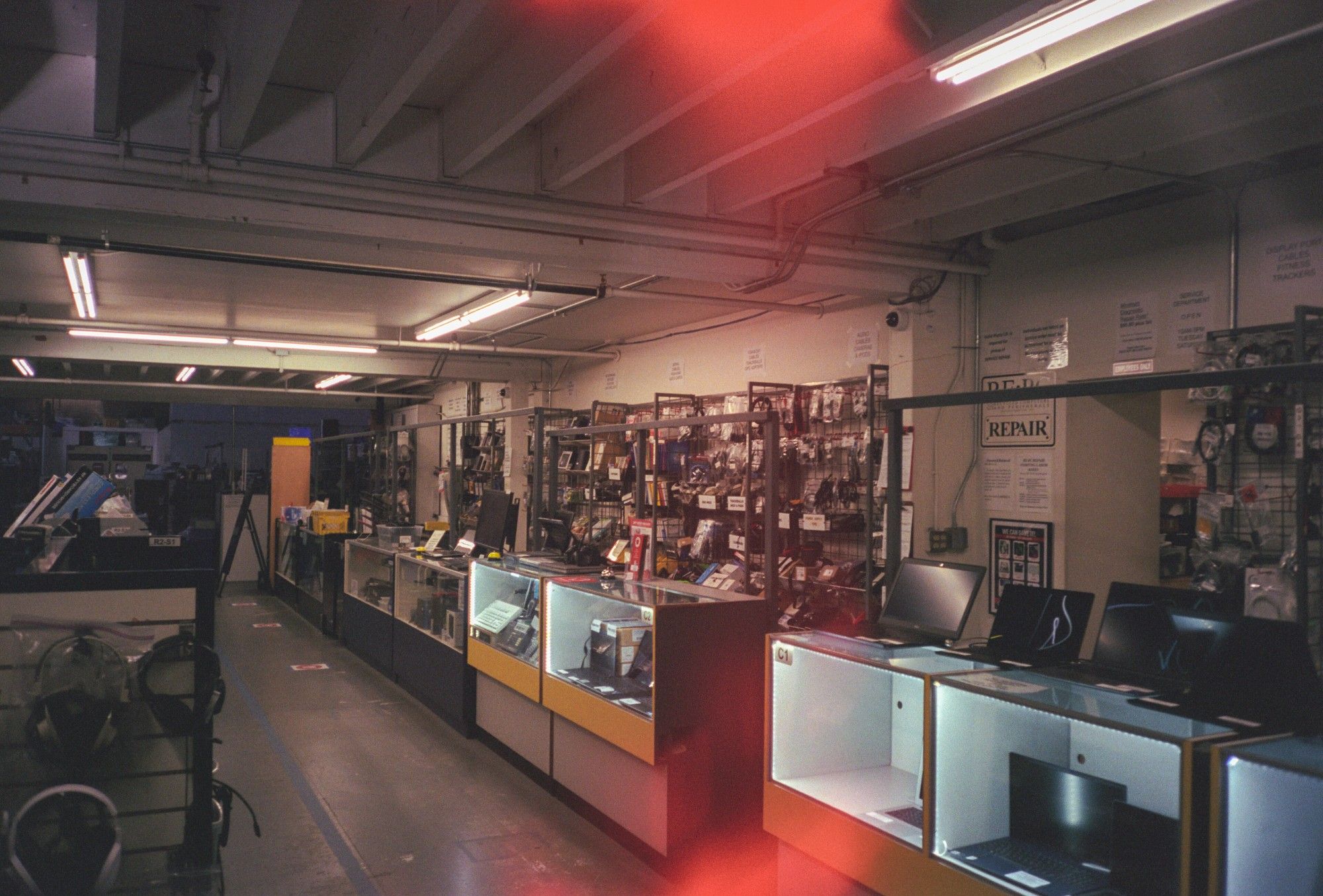 A photo of some shelving and display cabinets in REPC with laptops and other electronics miscellany