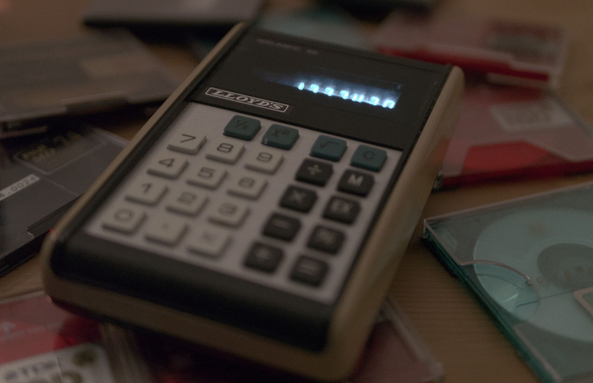 old calculator on a pile of minidiscs