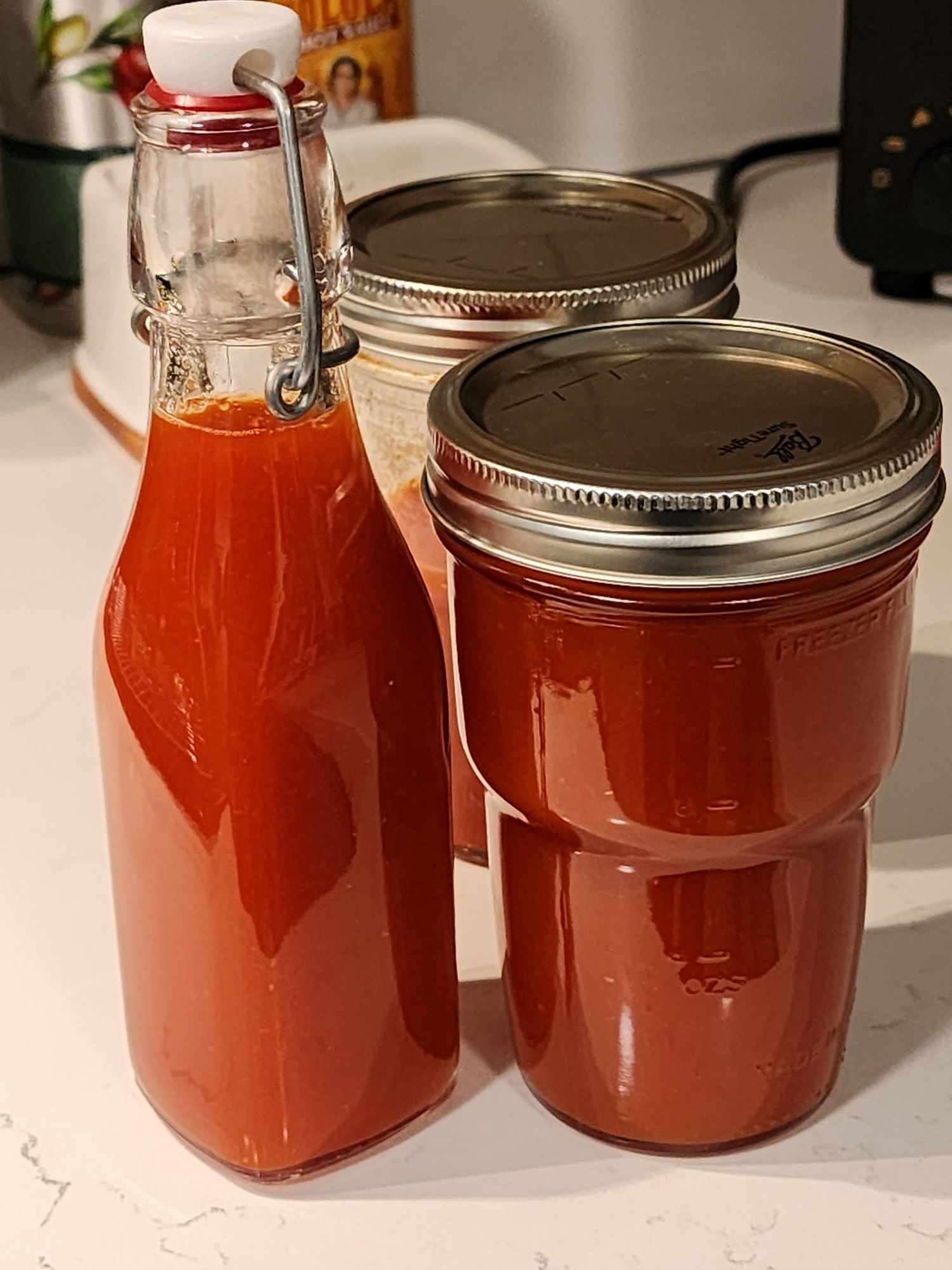 Three containers of hot sauce, very sexy hot sauce.