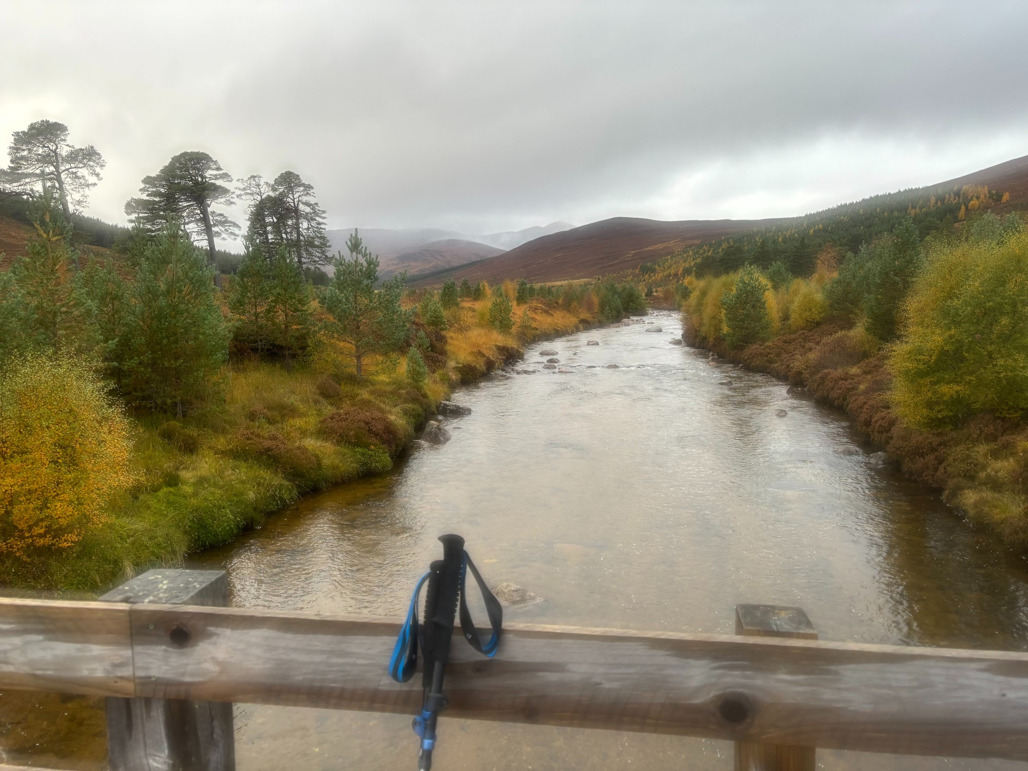 The Lui rivers seen from Black Bridge. In the distance mountains. Fall colours. 