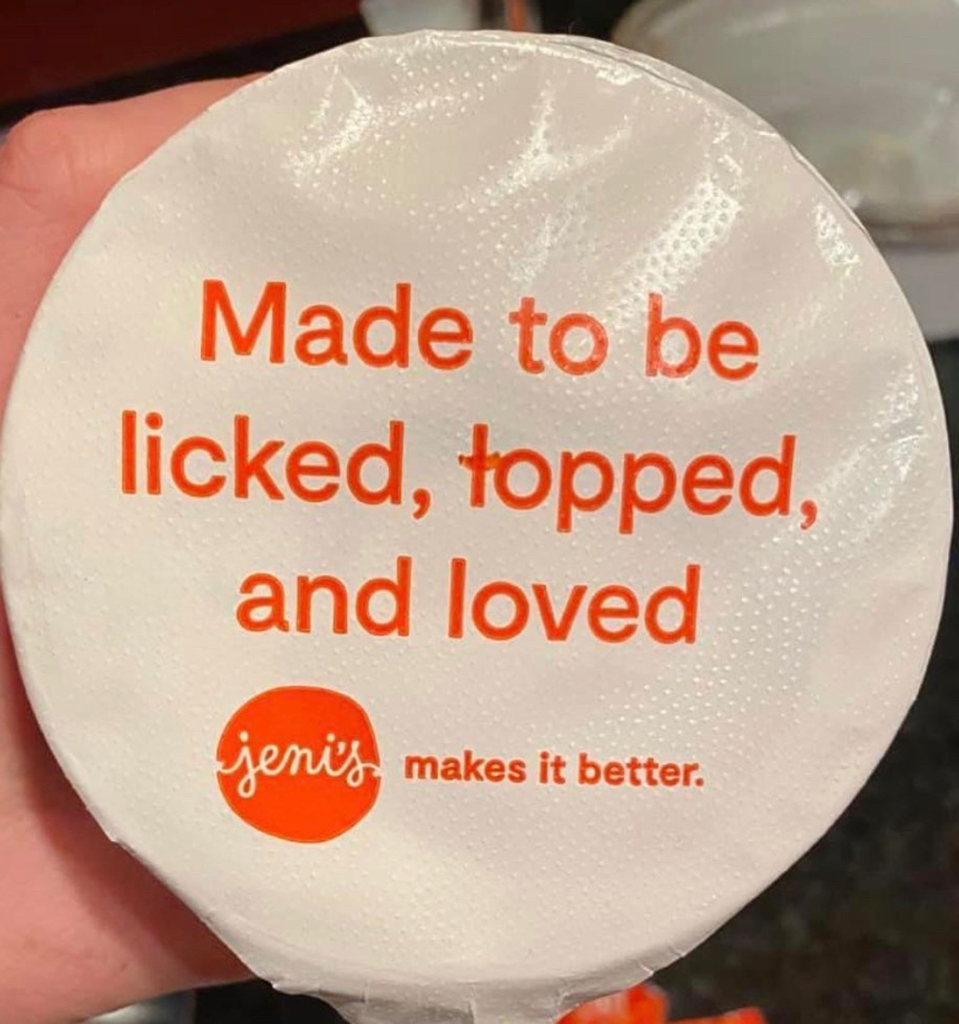 A tub of cream that says “made to be licked, topped, and loved”