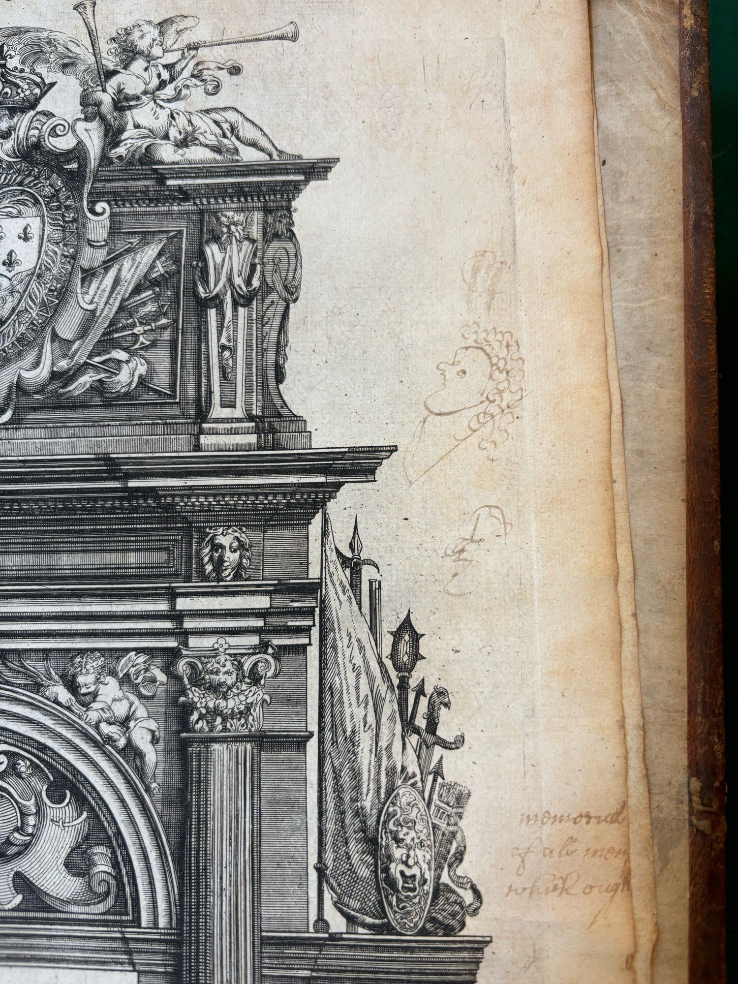 Doodles in brown ink of a badly drawn and curly haired face in the margin of a military triumphant arch, composite, in Alexander Francine’s  New Book of Architecture, 1669. Plate 39