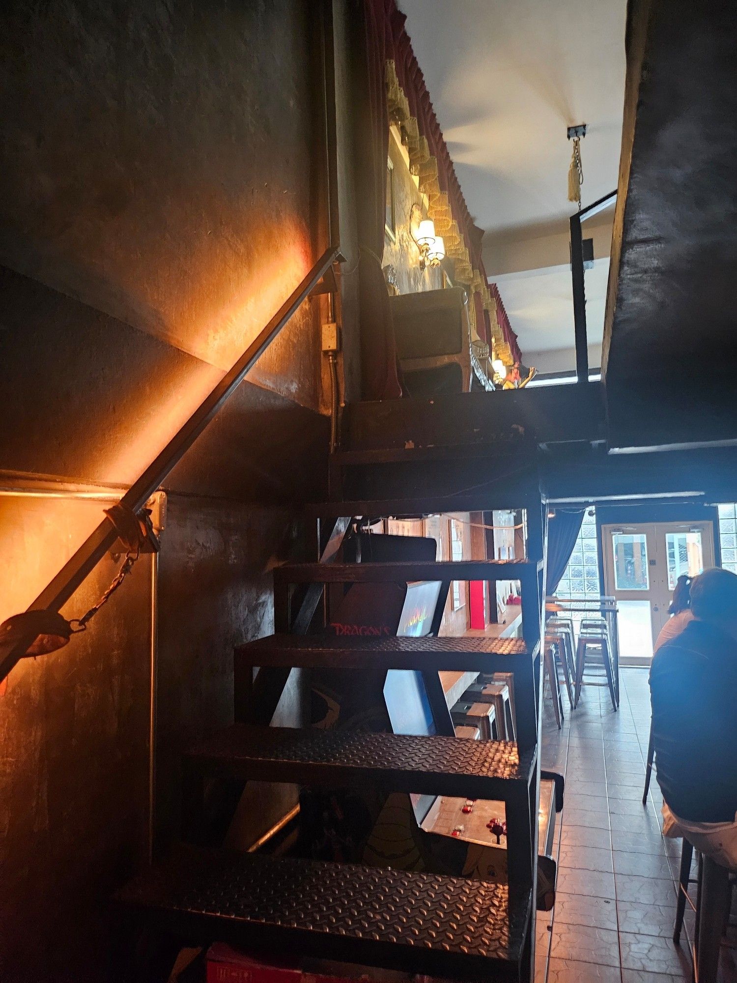 Apparently I forgot to take a photo of the door, but trust me, this looks a lot darker from the other end... The inside of "Hair of the Dog" bar off Sukhumvit Road. Metal stairs lead you up...