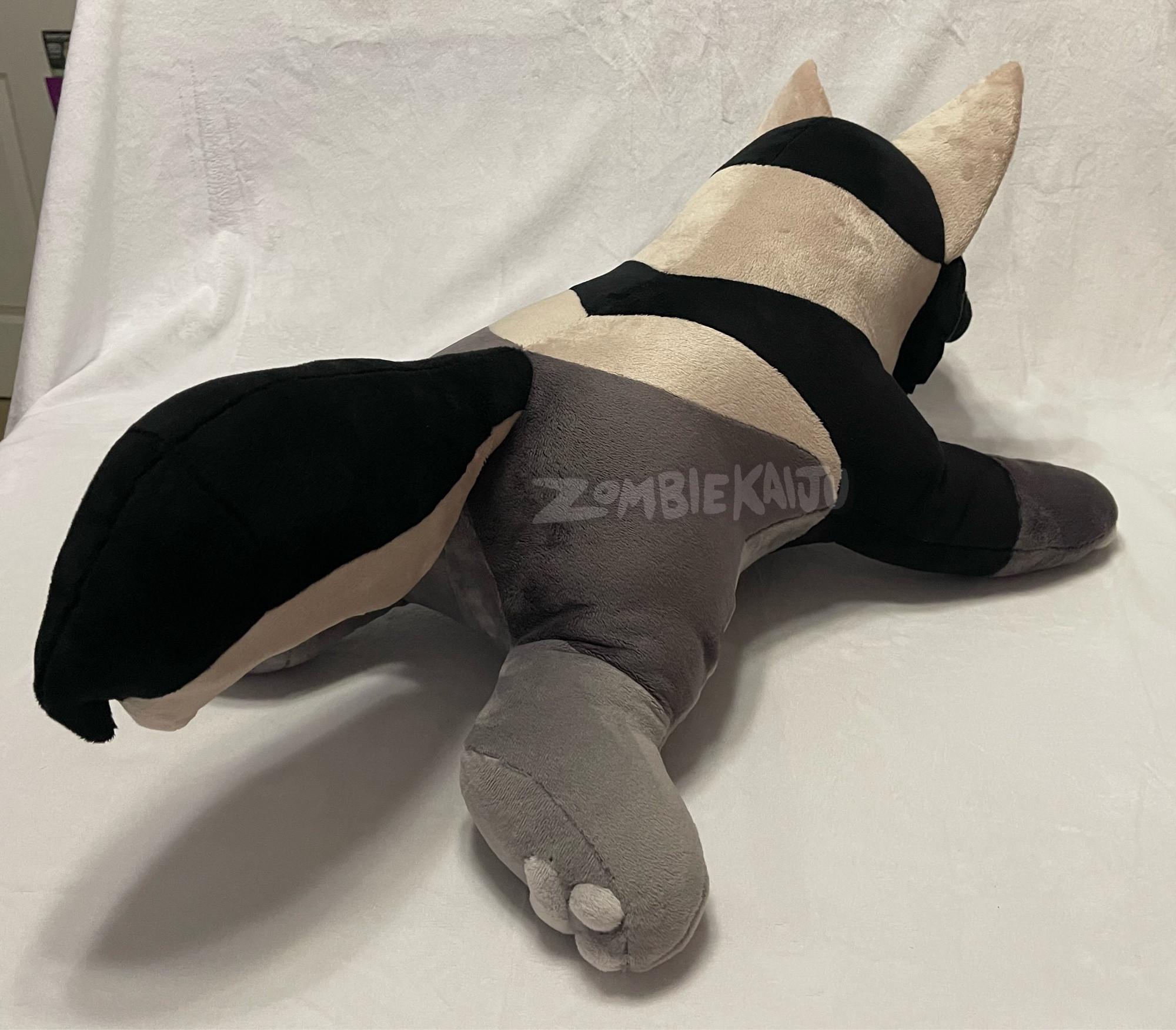 same handmade plush photographed from behind