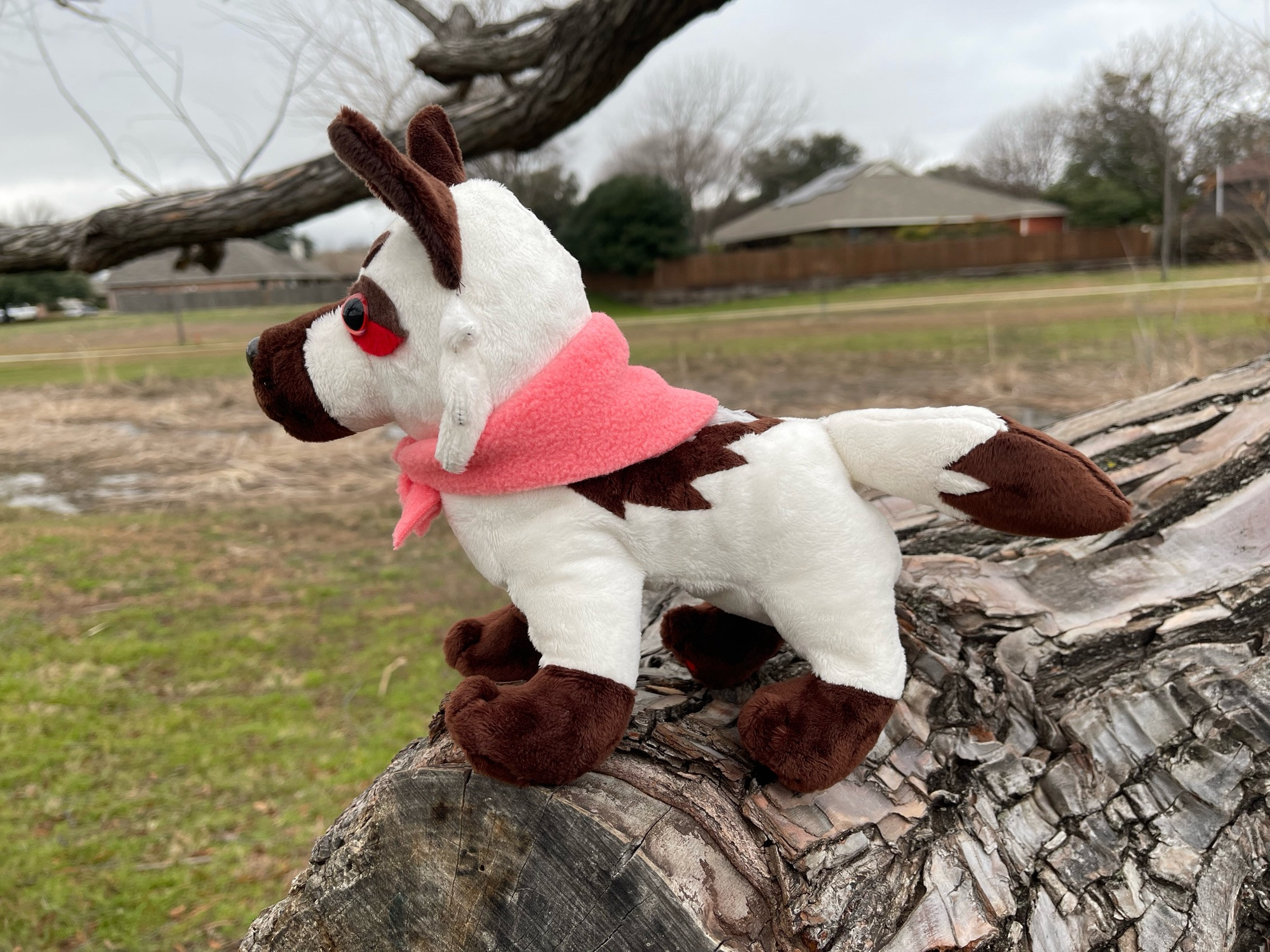 same plush, now standing on all four legs facing the left side of the screen, the legs are supporting the plush on their own, showing that the plush can assume a sitting or standing position with no human help required for balance!