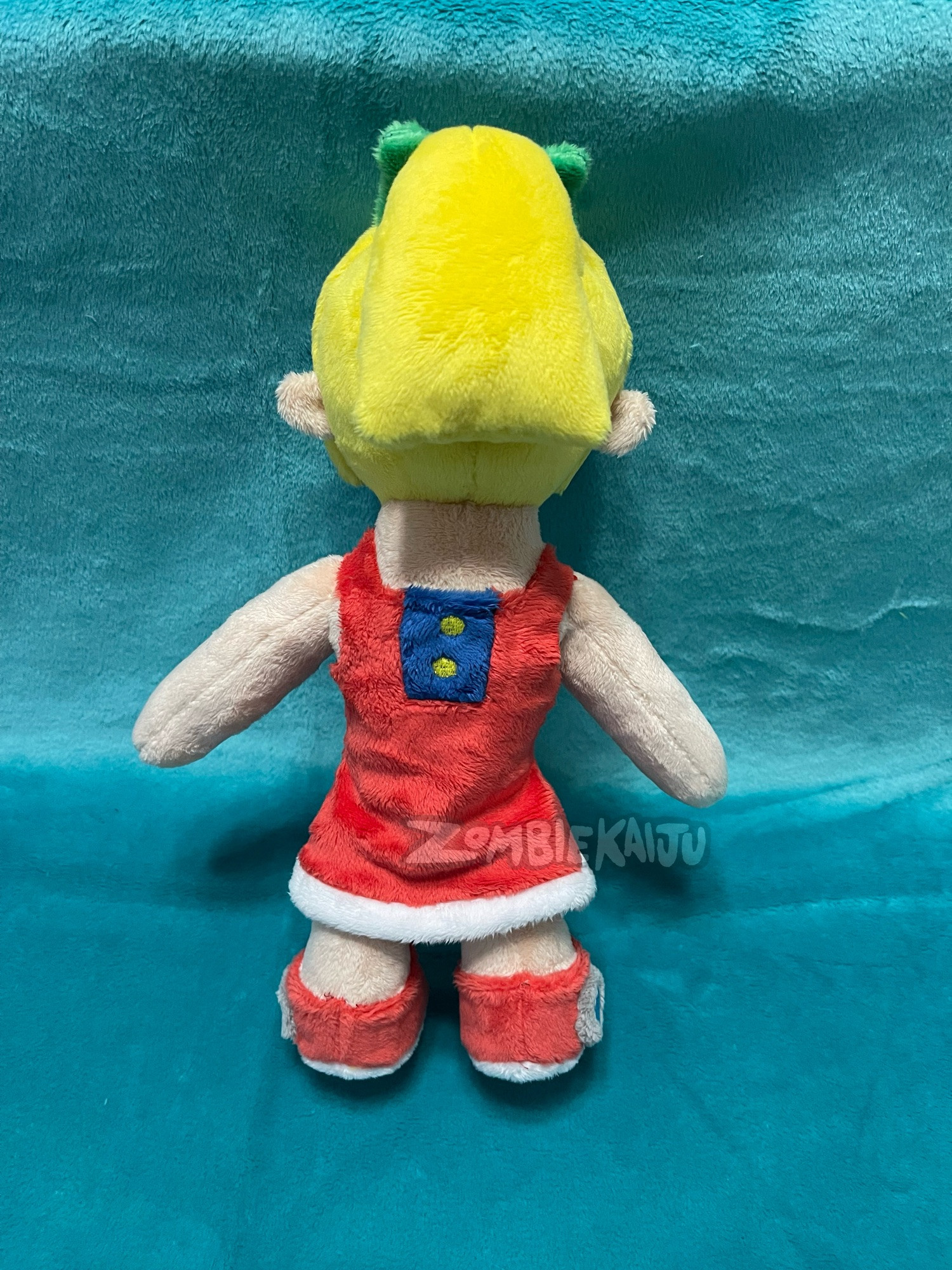 same plush from behind, showing that she has a ponytail