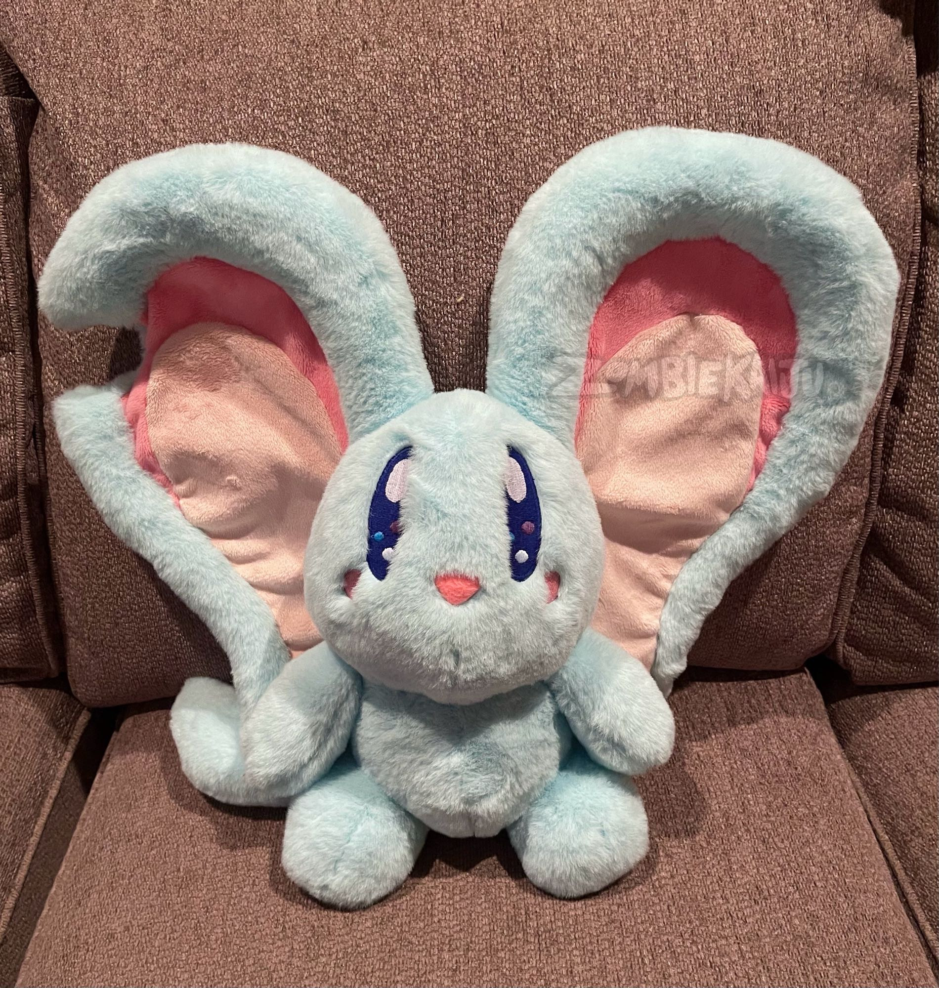 large handmade plush of the character Elfilin from Kirby and the Forgotten Land.  It is a light blue cartoon mouse with huge ears.  it is made with an extra fuzzy fabric