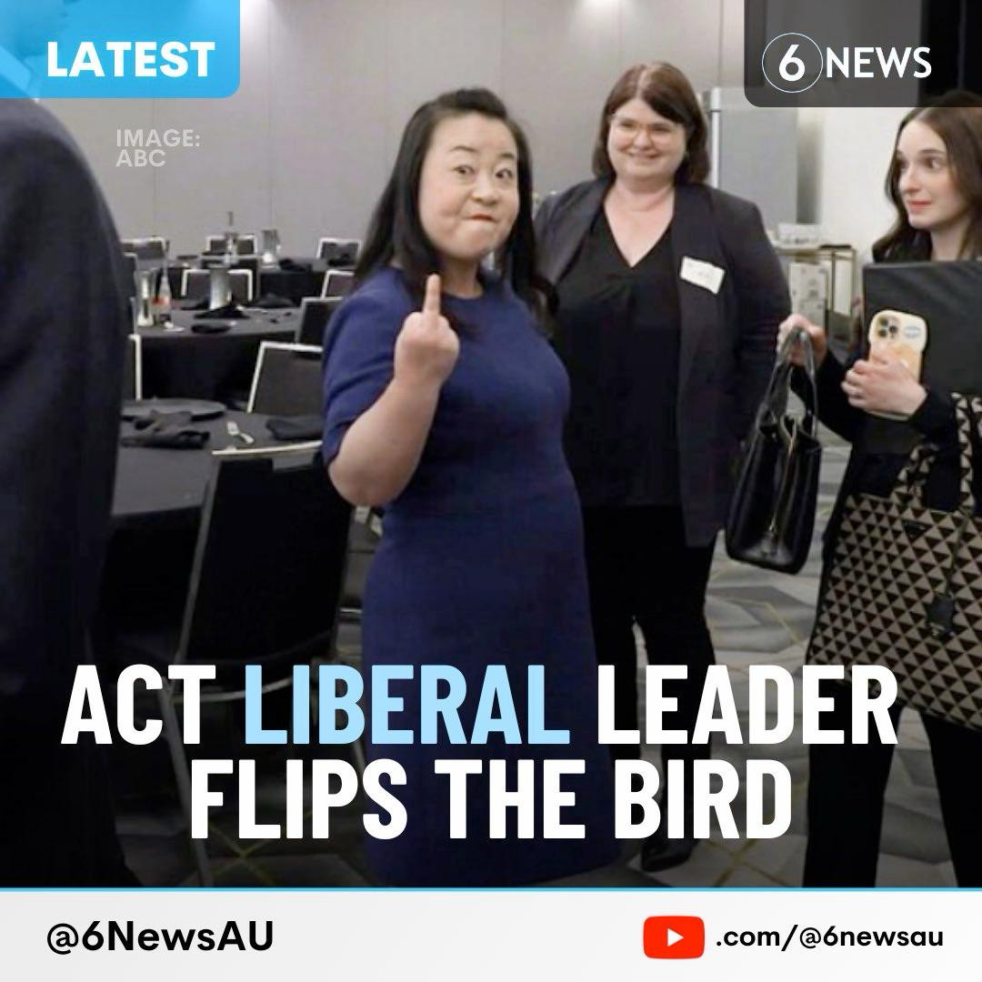 A photo of the Leader of the Opposition in the ACT, Elisabeth Lee, giving the finger to journalist Ian Bushnell after an interview