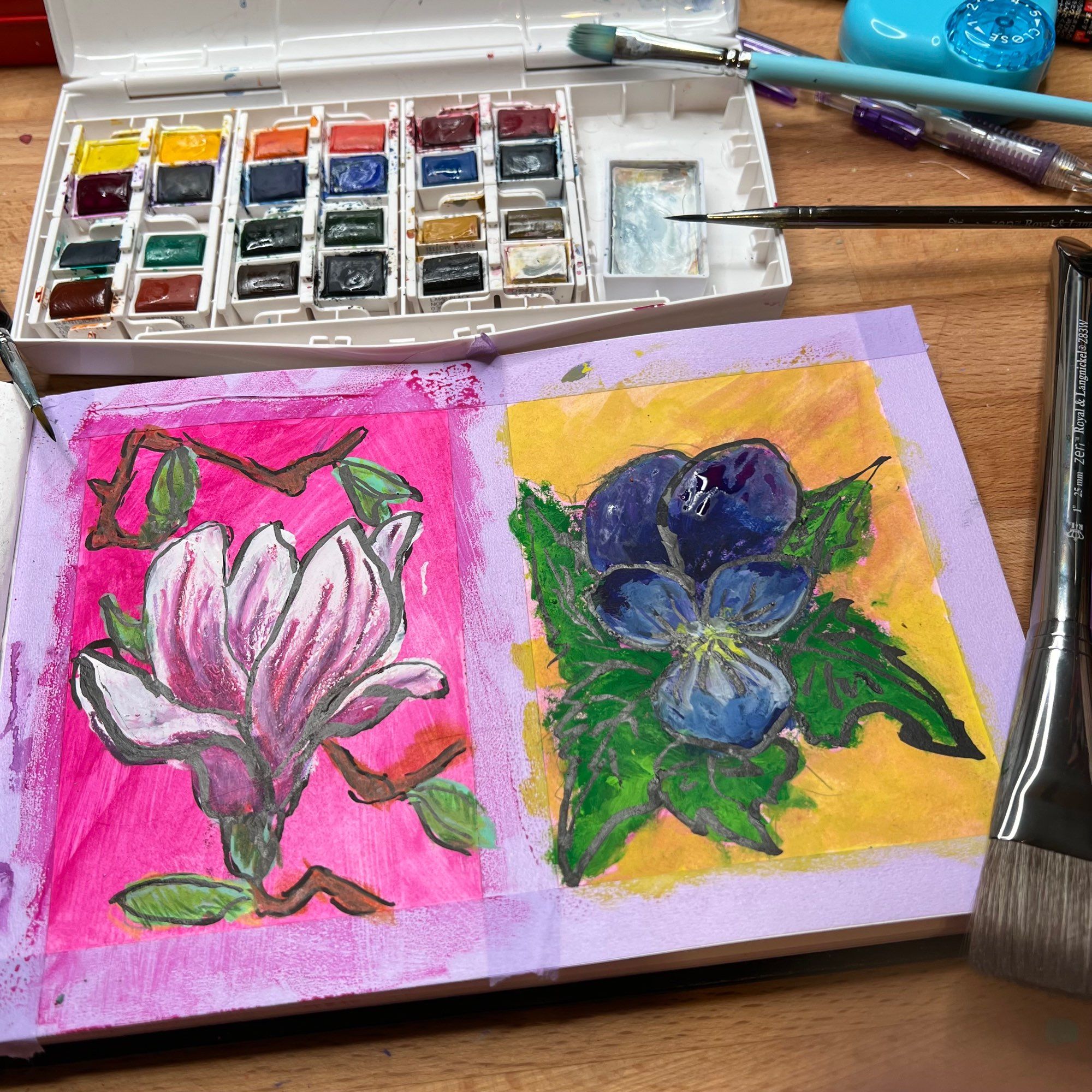 Sketchbook with two paintings, 1) of a tulip magnolia blossom and 2) off a blue Pansy