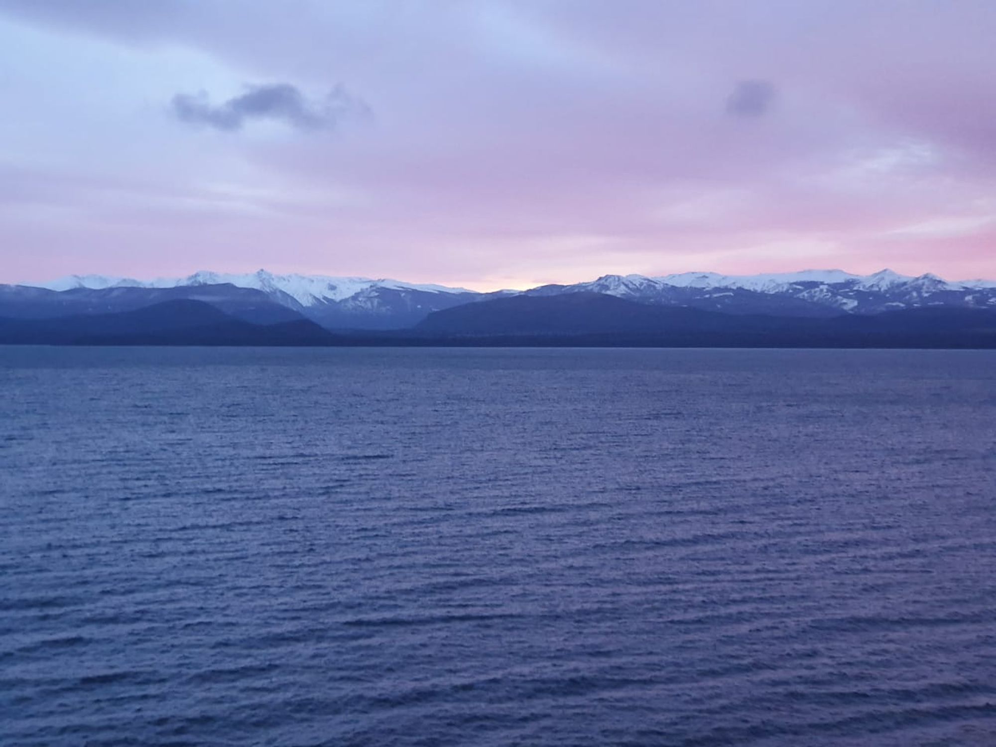 own photo taken by my niece on a cloudy evening in July, 2019, at San Carlos de Bariloche, ARG
on the forefront and bottom of the pic the blue water of Lake Nahuel Huapi. to the background, the sky turns lilac as the sunset is hidden by the Andes mountain range, which have blue hues too