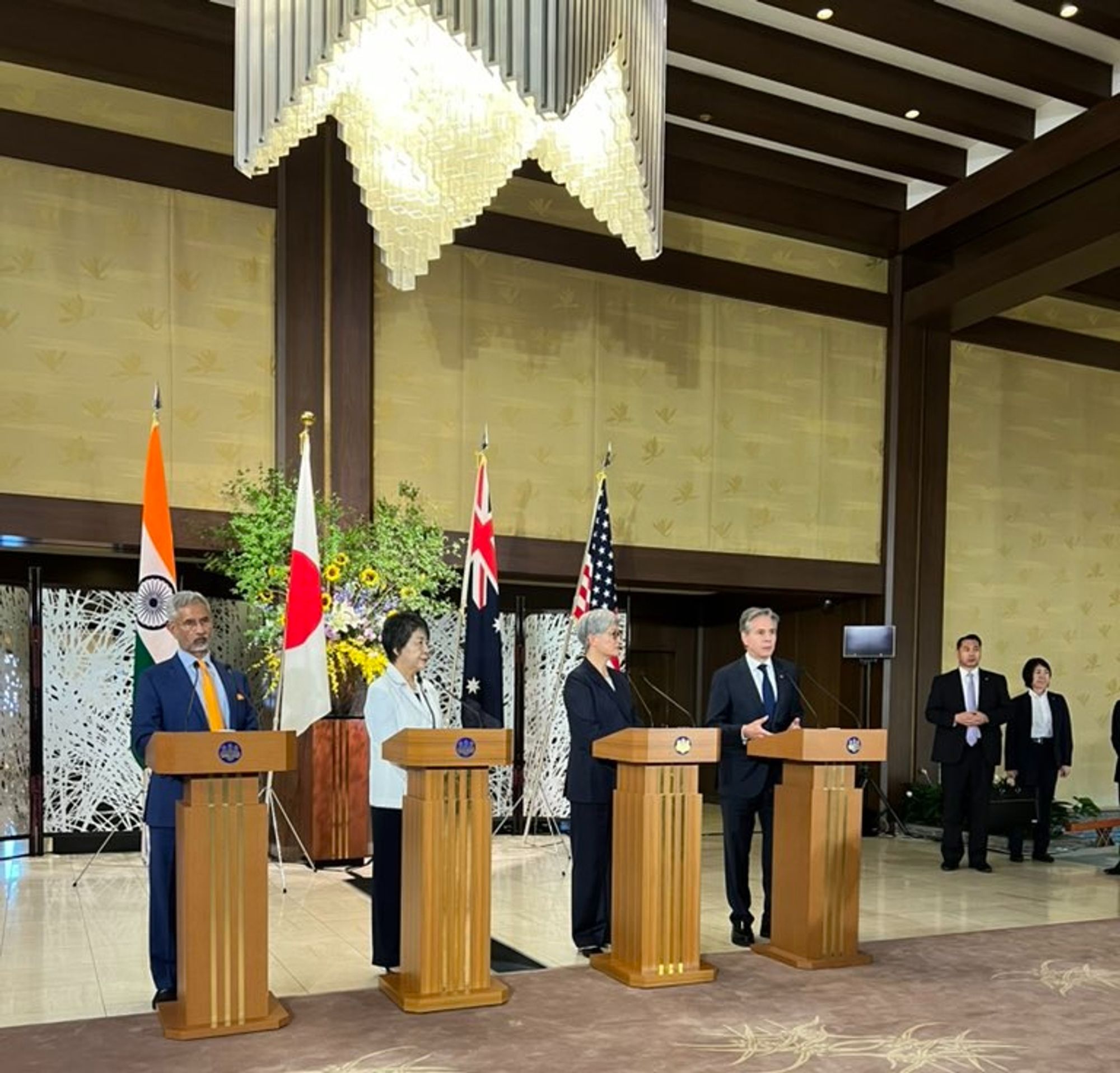 Photo by Daniel Flatley of Tony Blinken speaking at a lectern (with other world leaders at three other lecterns)