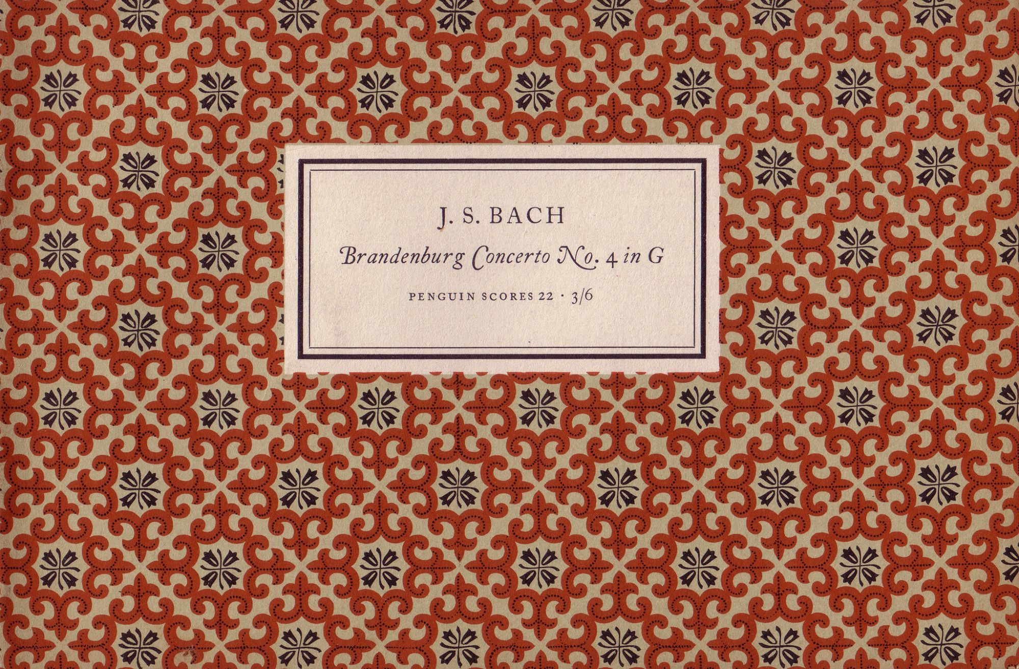 Cover of Bach score with repeated pattern of intricate orange emblemson on beige ground