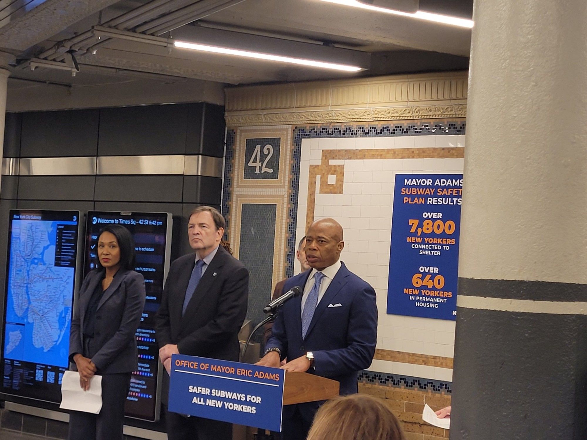 Photo by Rebecca C. Lewis of Mayor Eric Adams inside the Times Square subway station, standing behind a podium with other members of his administration nearby, including interim NYPD Commissioner Tom Donlon, who is reportedly about to step down.