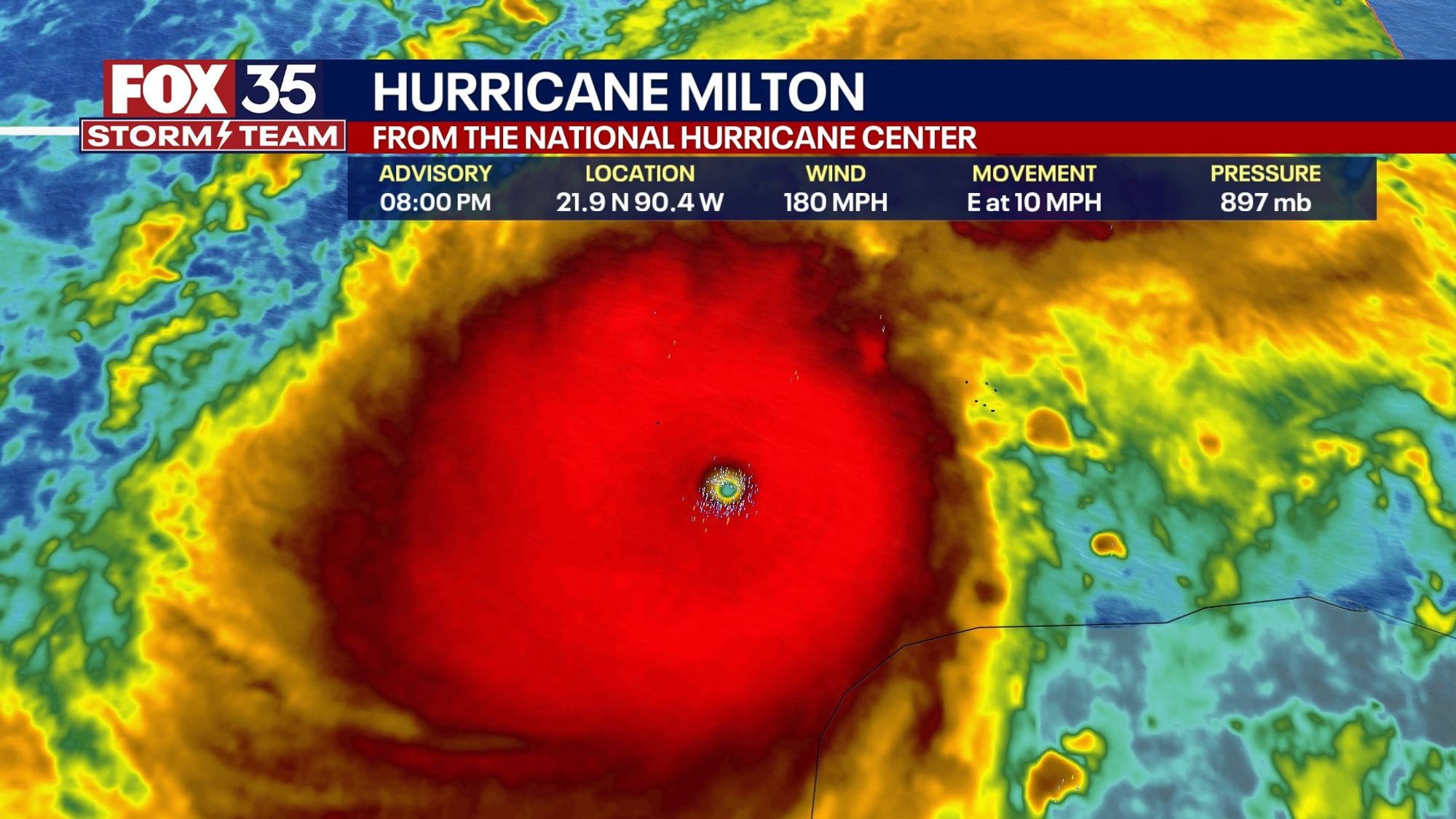 Fox35 storm team graphic of Hurricane Milton from the National Hurricane Center. Now zoomed out, shows eye of the storm as tiny and around it an enormous intense hot red swirl, and around it yellow and green, superimposed on a map of the water off the shore of Florida.