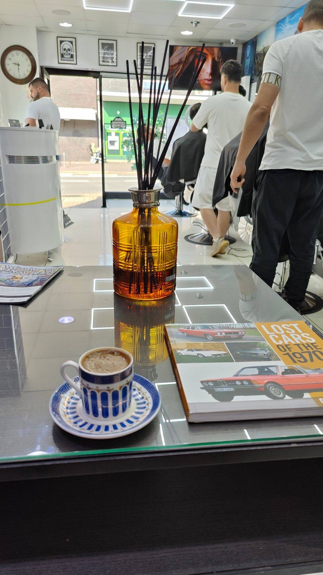 At the barbers with incense on the table and a Turkish coffee.