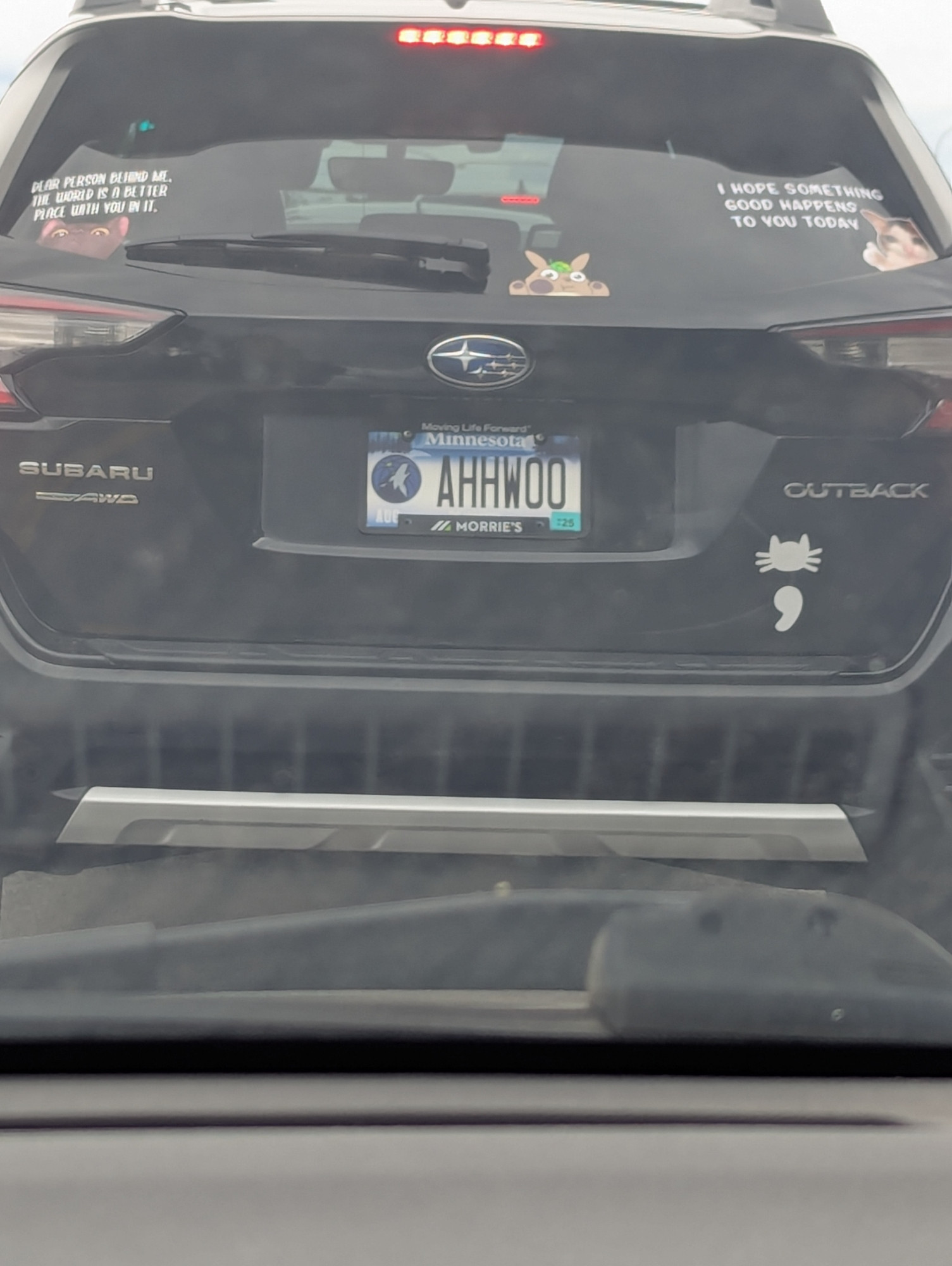 Timberwolves logo on a Minnesota license plate that reads "AHHWOO."