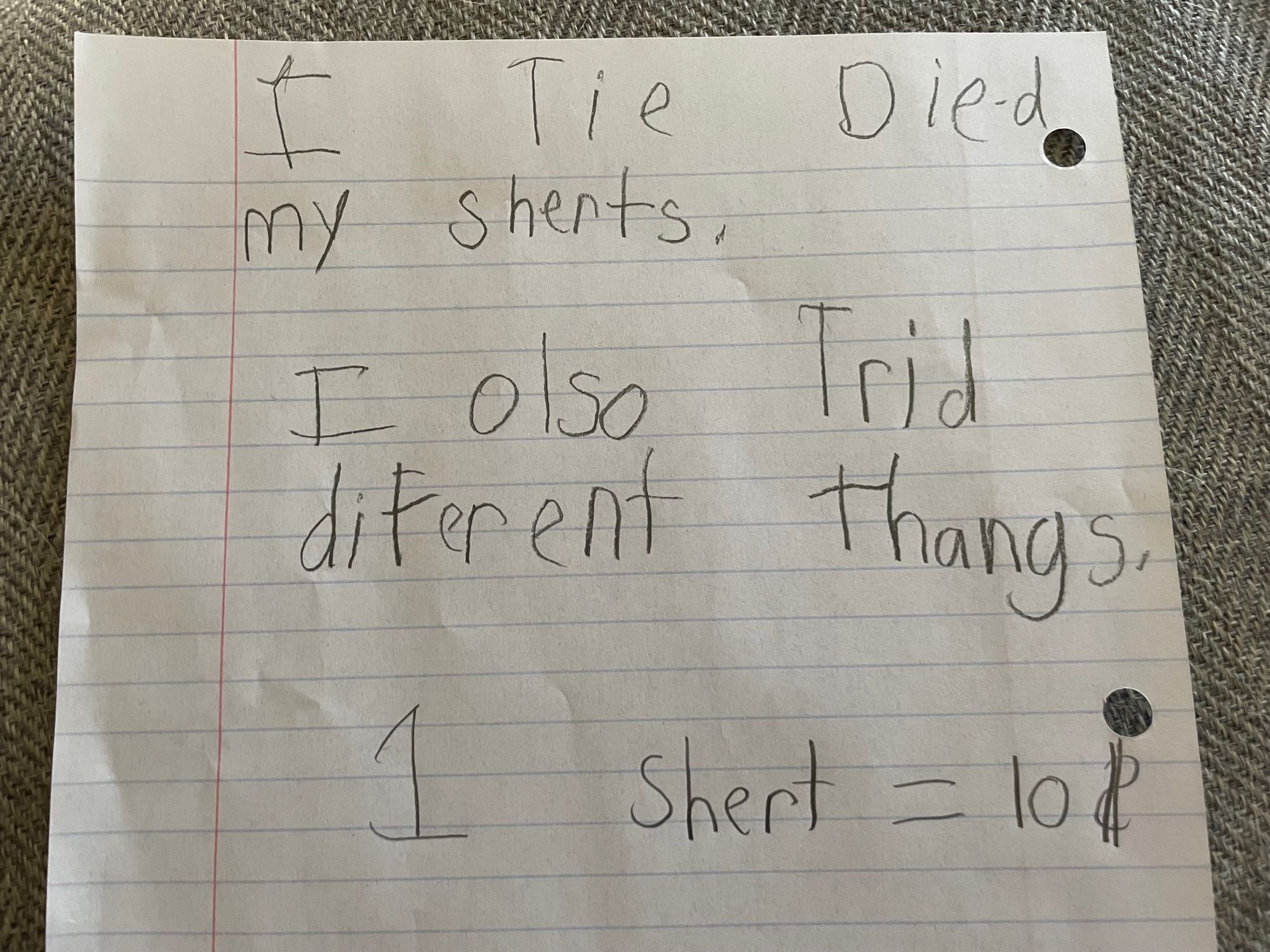 Kids note that says “I tie die-d my sherts. I olso trid diferent thangs. 1 shert = 10$”